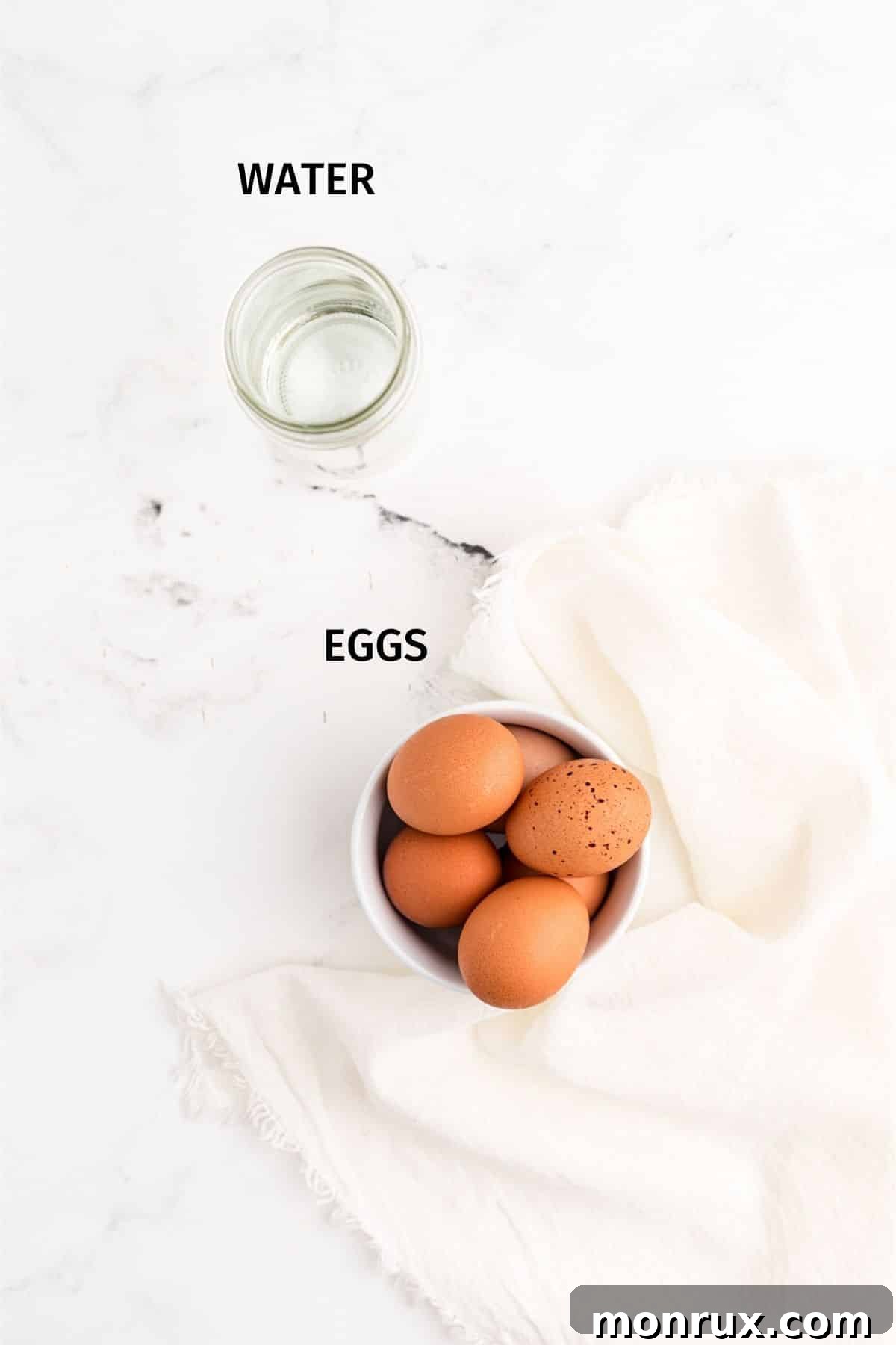 Eggs and water laid out on a table with labels, ready for the crockpot hard-boiled egg recipe.