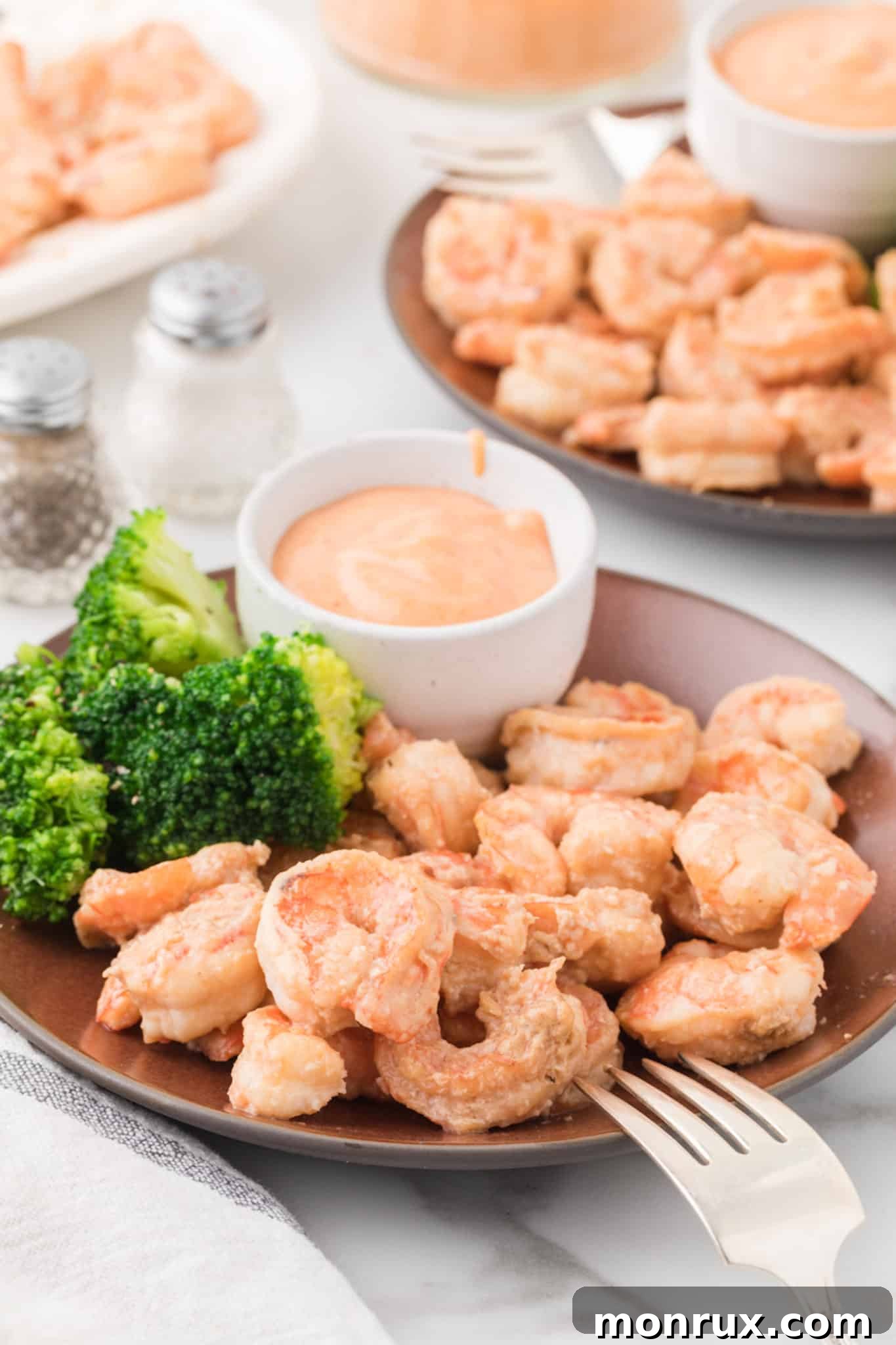 A vibrant plate of perfectly cooked hibachi shrimp served with fresh, green broccoli.