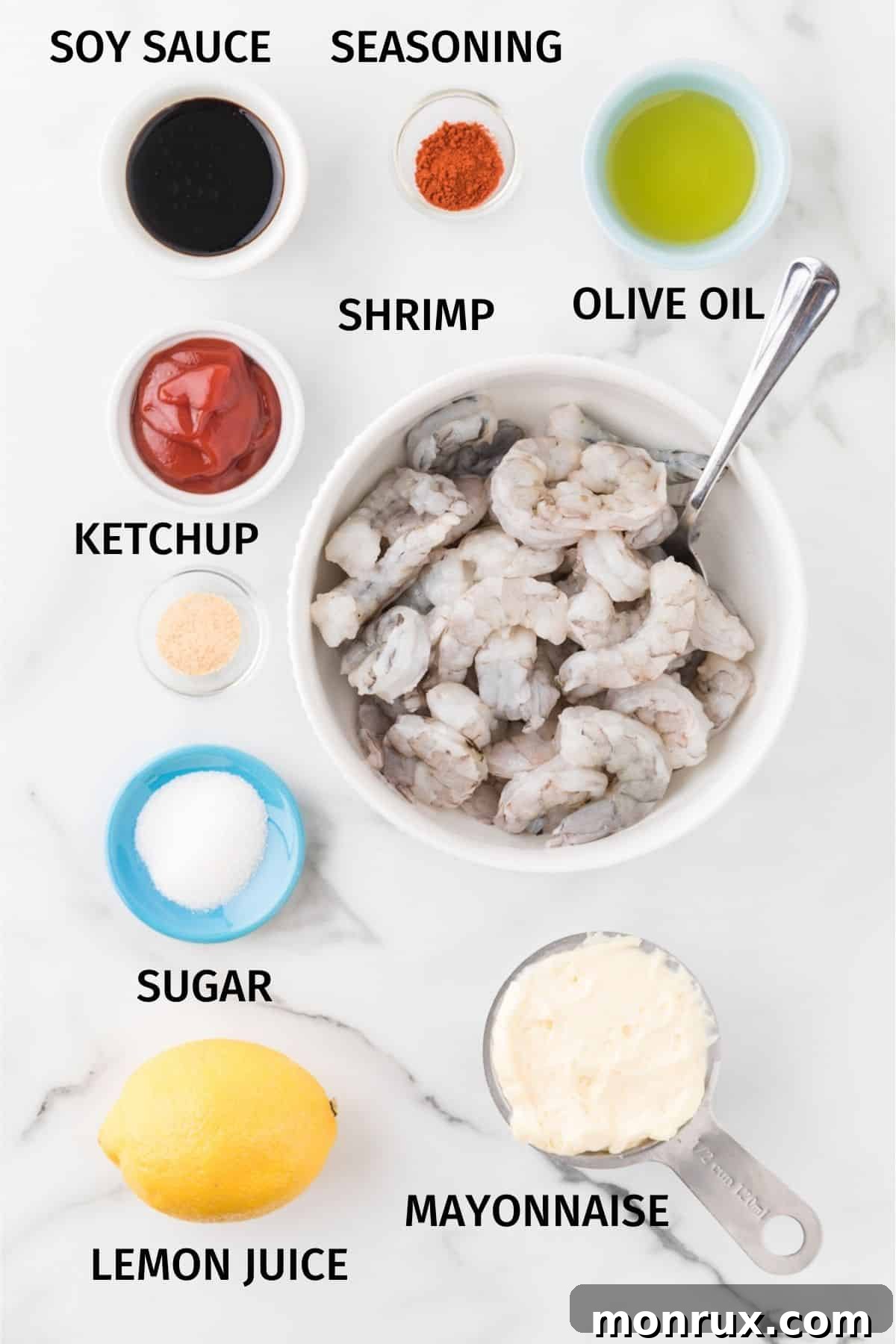 A collection of fresh ingredients laid out for making hibachi shrimp with white sauce.