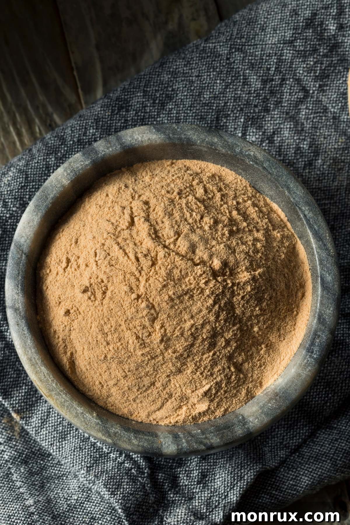 Fine brown lentil powder in a white bowl