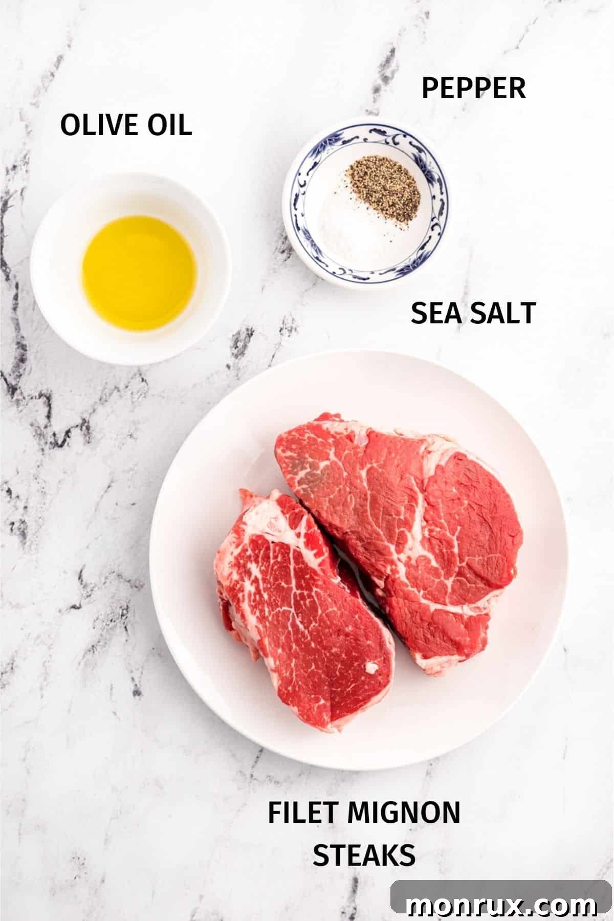 Ingredients for perfectly cooked air fryer filet mignon including two steaks, olive oil, and a small bowl of salt and pepper.