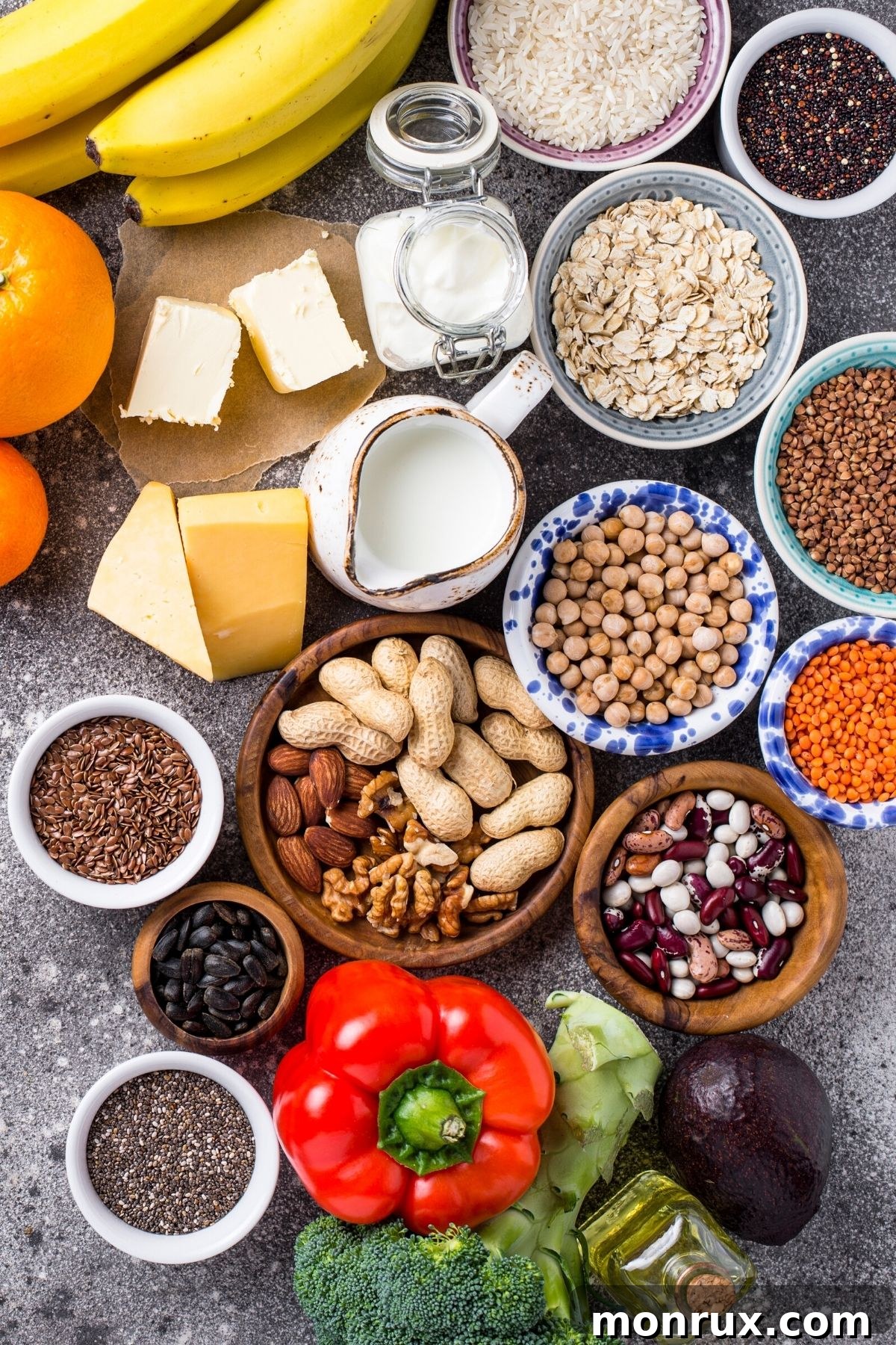 Bowls of nuts, beans, lentils, and seeds on a table, symbolizing diverse plant-based nutrition.