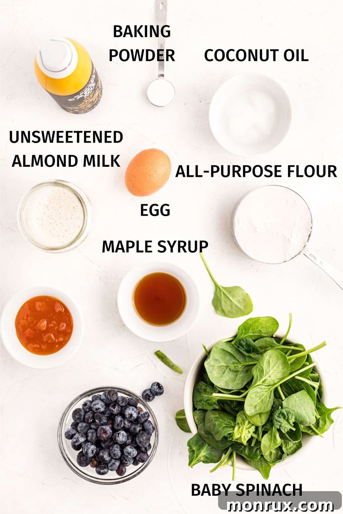 A flat lay image showing the key ingredients for green waffles neatly arranged on a kitchen counter.