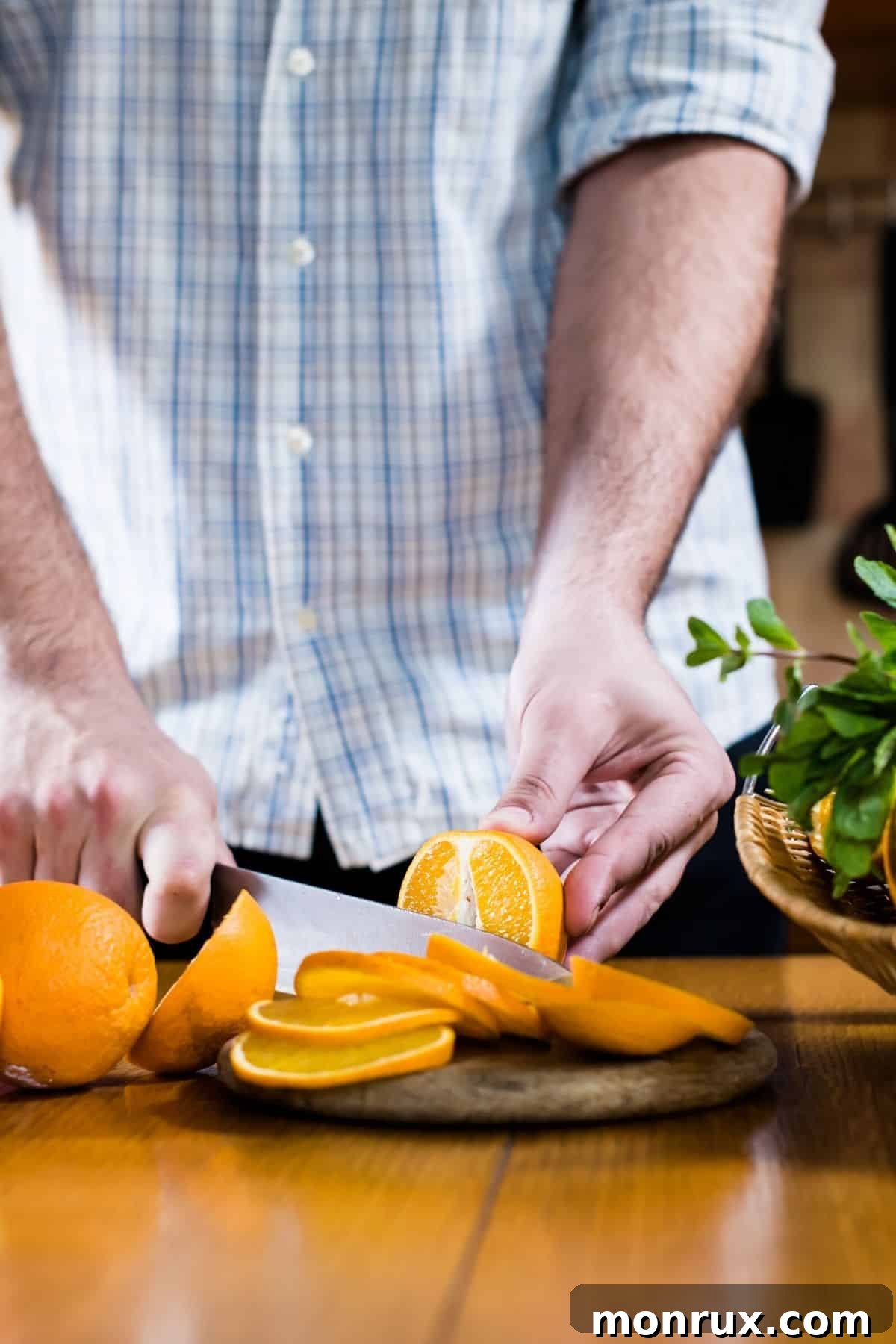 A chef expertly slicing a vibrant Spanish orange on a cutting board, preparing it for a gourmet dish or fresh juice.