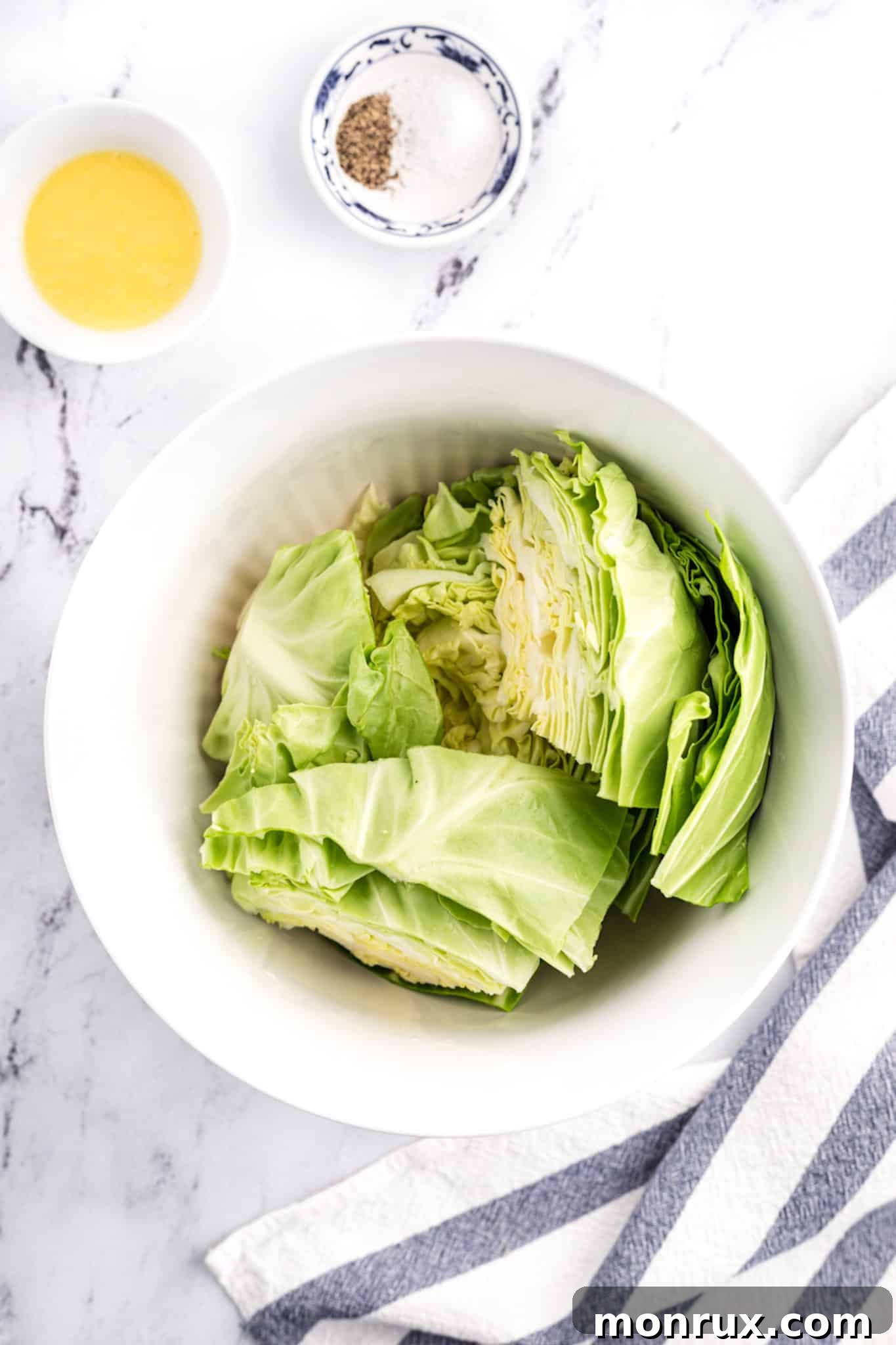 Perfectly chopped cabbage coated in seasoning and oil, ready for the air fryer, nestled in a pristine white mixing bowl.