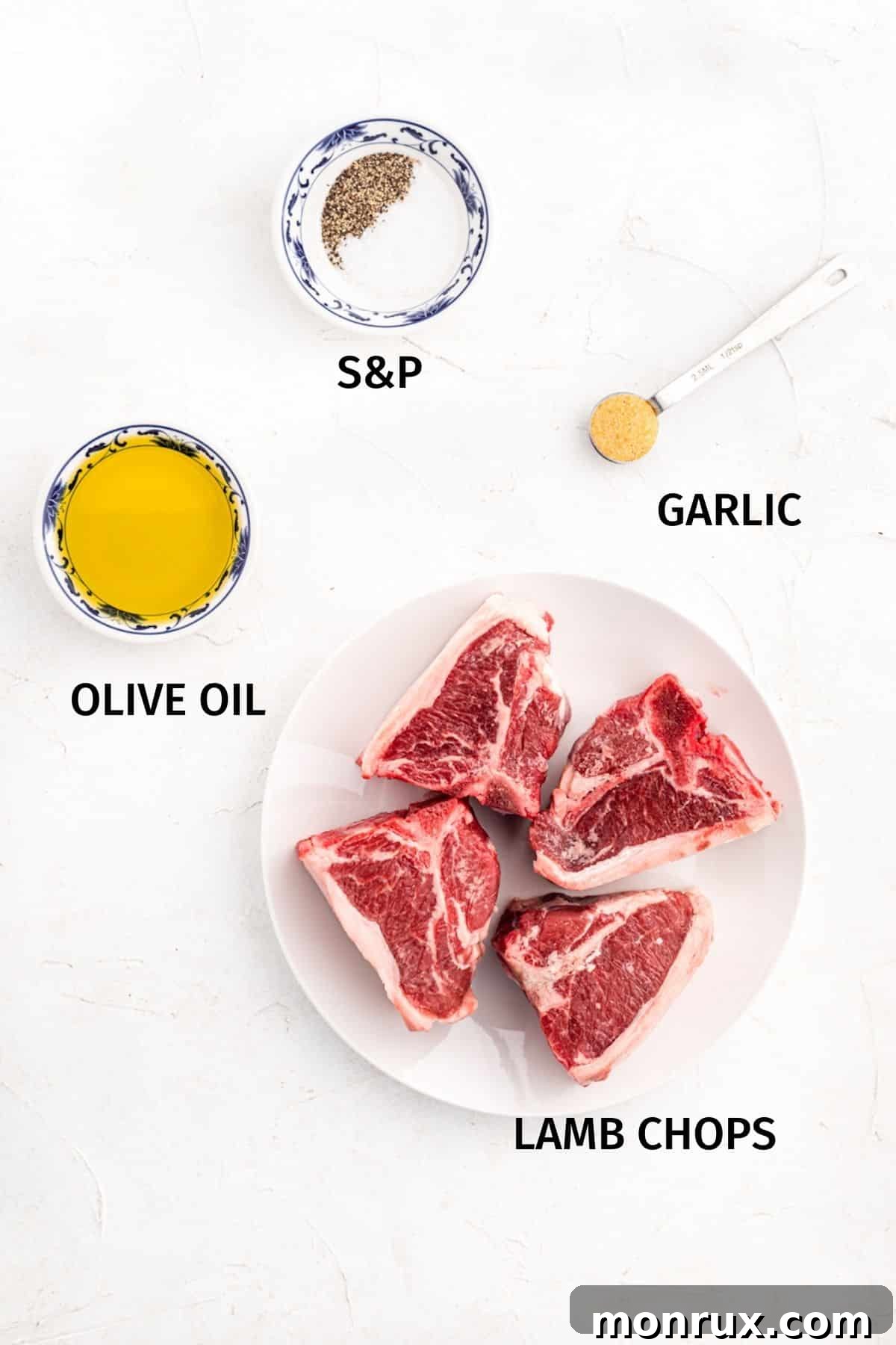 Ingredients to make air fryer lamb chops set out on a white surface.