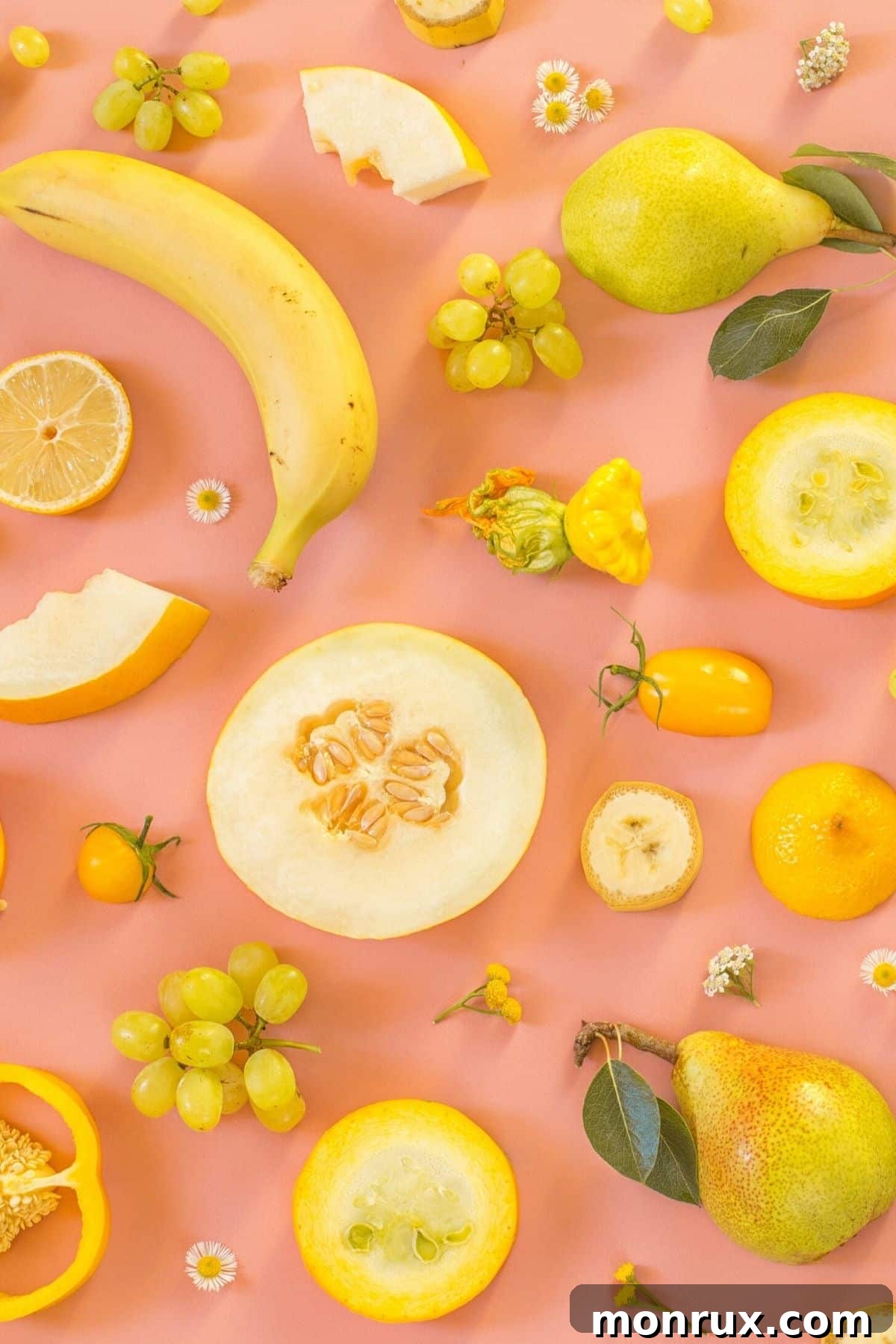 A banana, pear, melon, and other yellow fruits arranged aesthetically.