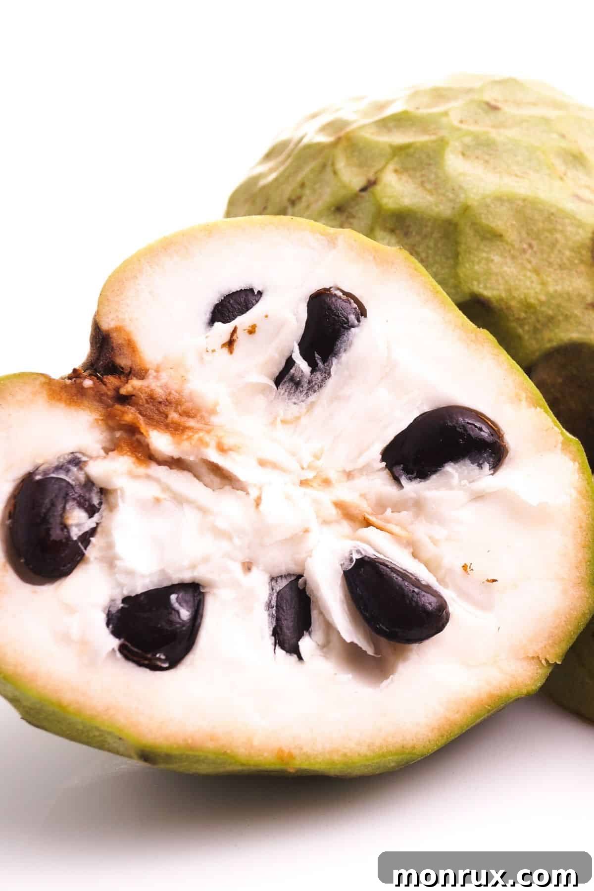 cherimoya cut in half on table.