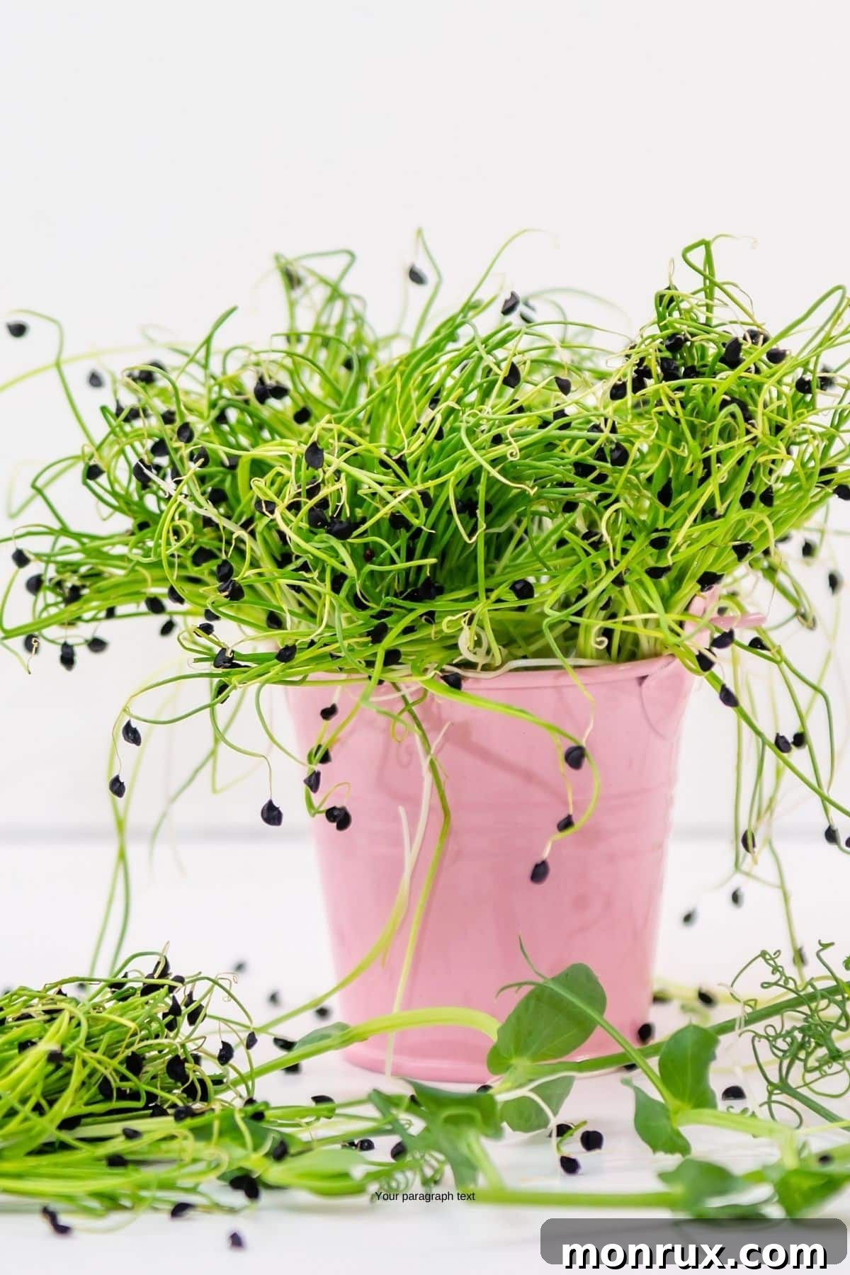 A generous quantity of slender onion microgreens gathered in a wooden bowl on a rustic table, showcasing their delicate structure.