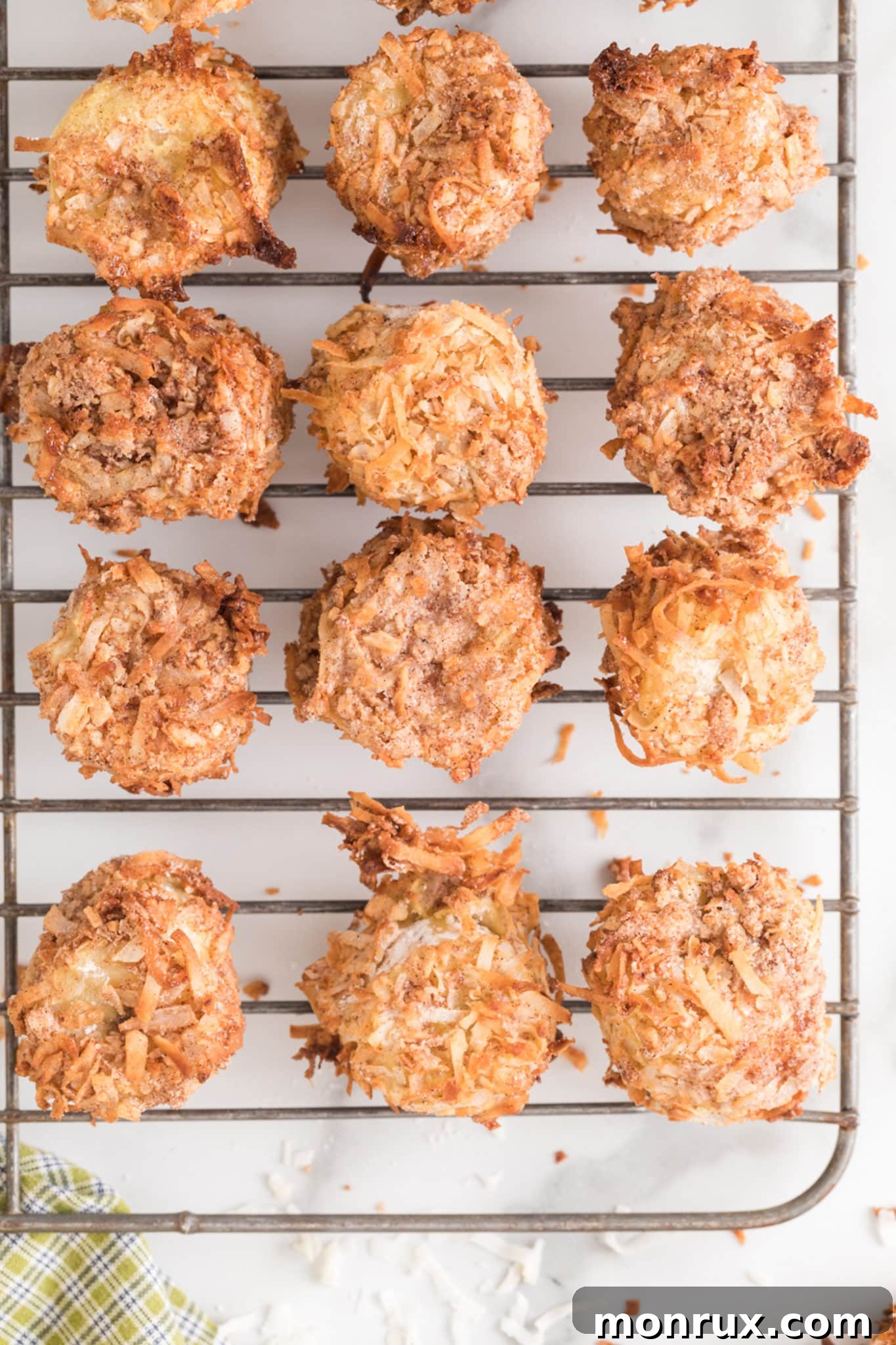 Freshly cooked, golden-brown banana fritters resting on a wire cooling rack, ready to be enjoyed.