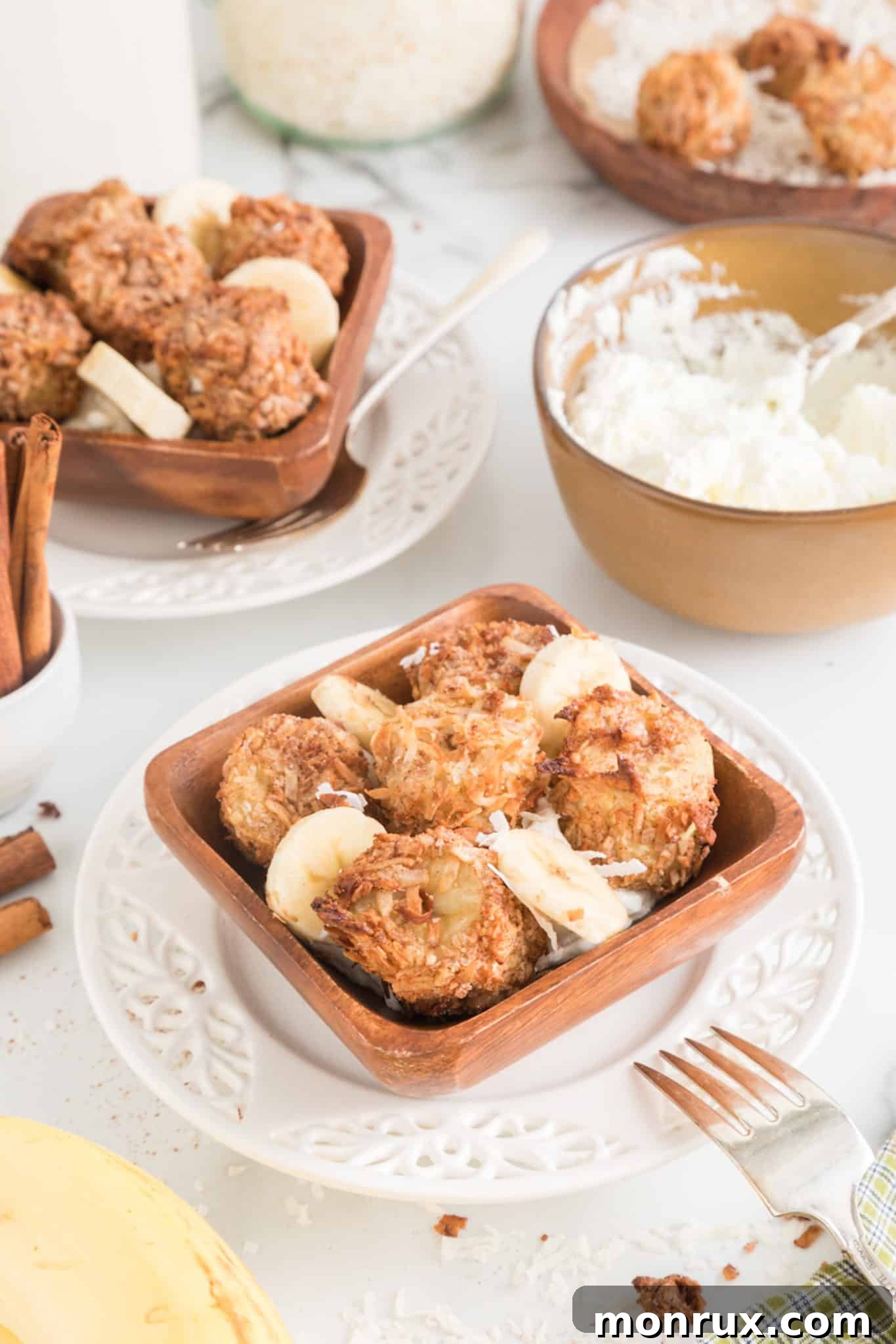 A delightful presentation of air fried banana fritters served in a rustic bowl, generously topped with fresh whipped cream, inviting indulgence.