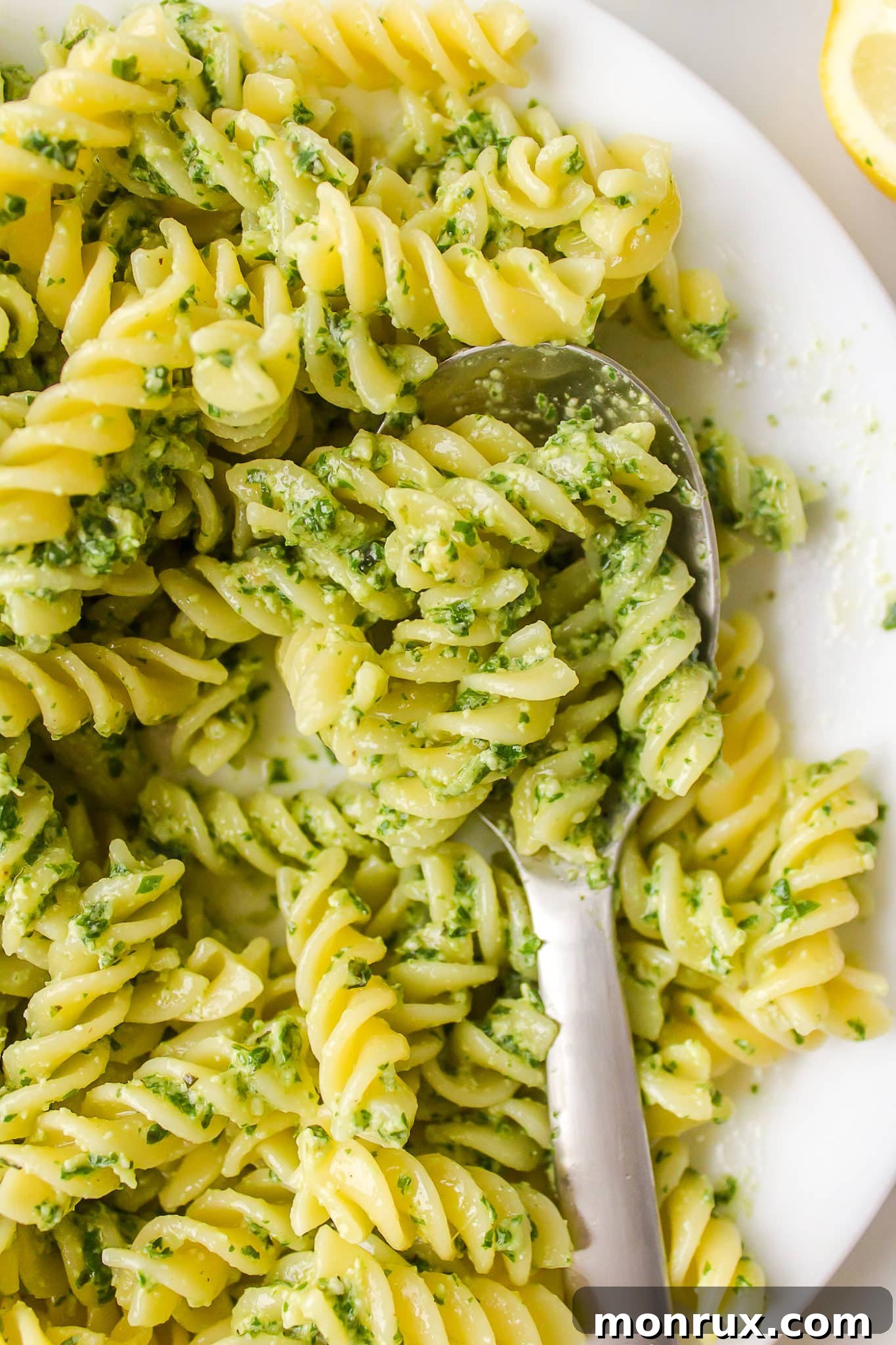A close-up shot showcasing the beautiful texture and vibrant green color of the dairy-free pesto pasta dish.