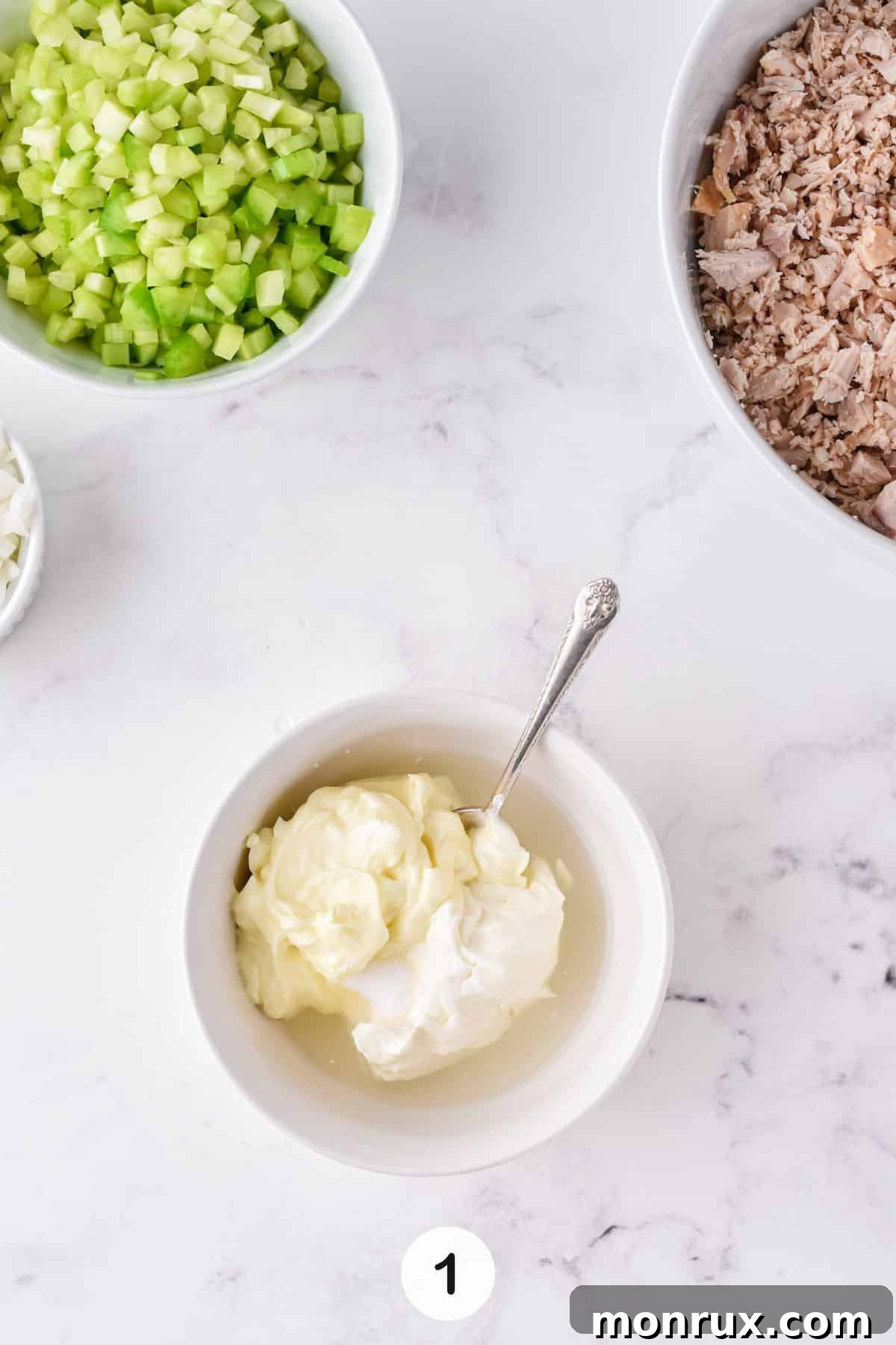 A bowl filled with a creamy, well-mixed dressing, showcasing the perfect consistency before being combined with chicken.