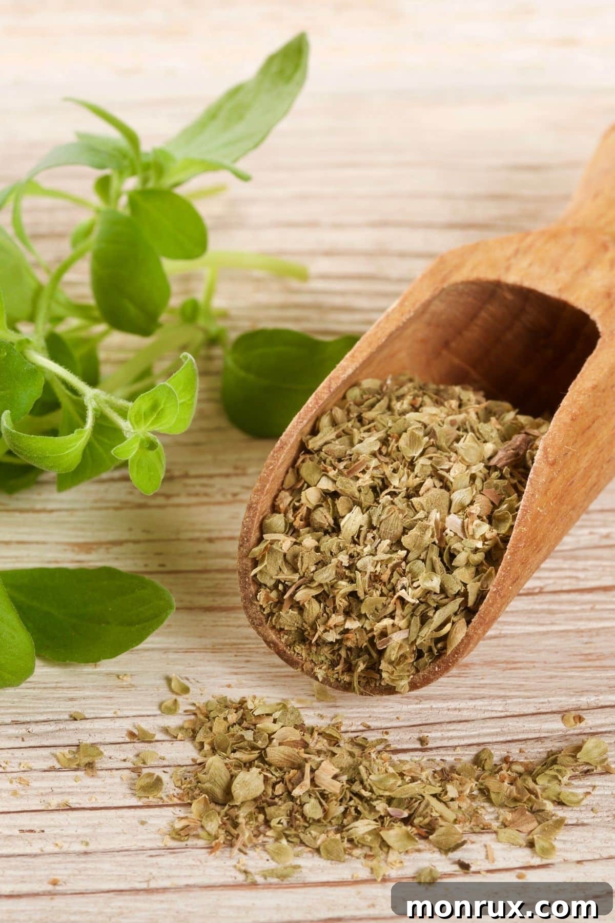 Dried oregano in a wooden spoon, ready for cooking.