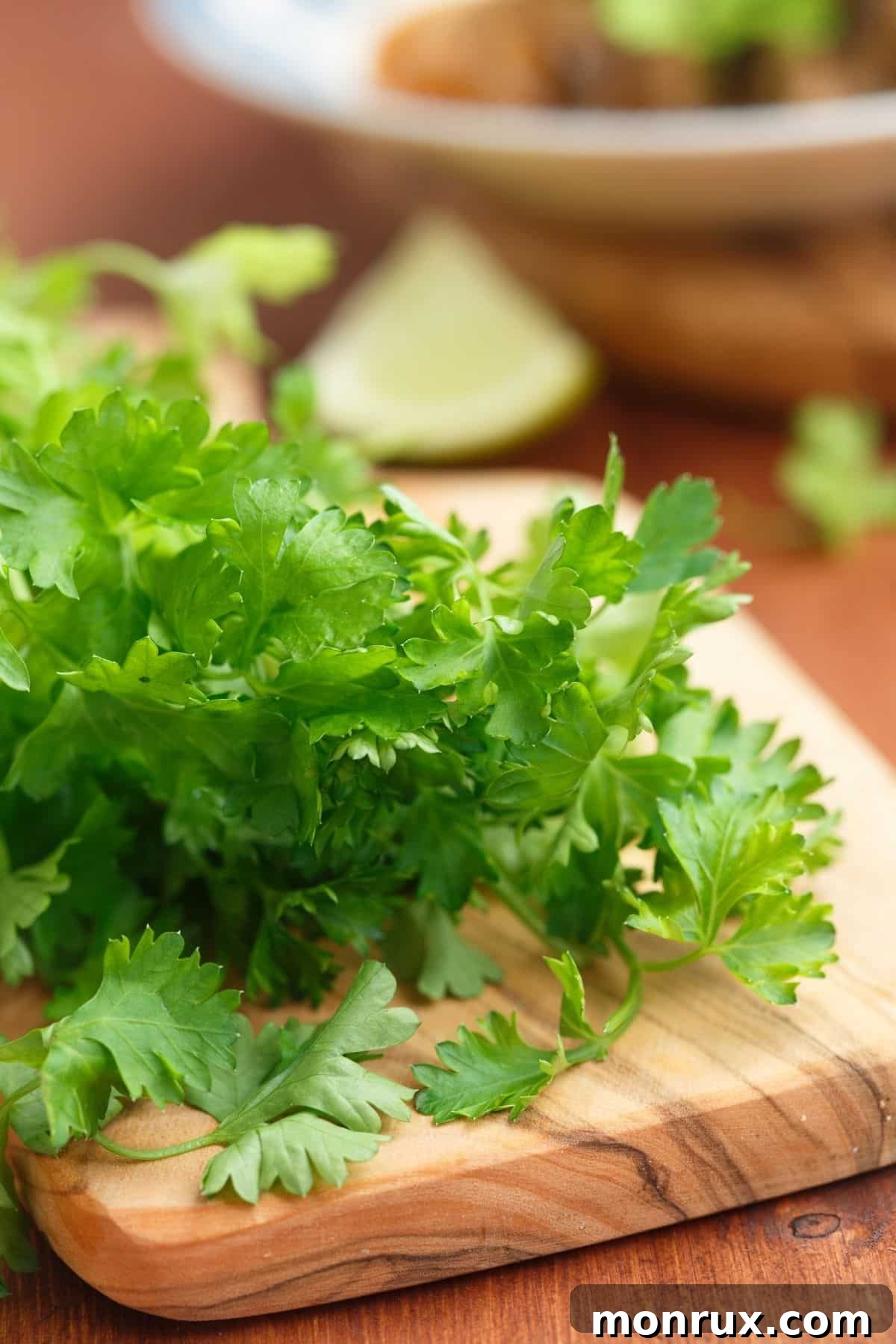 Fresh parsley on a wooden cutting board, brightly colored.