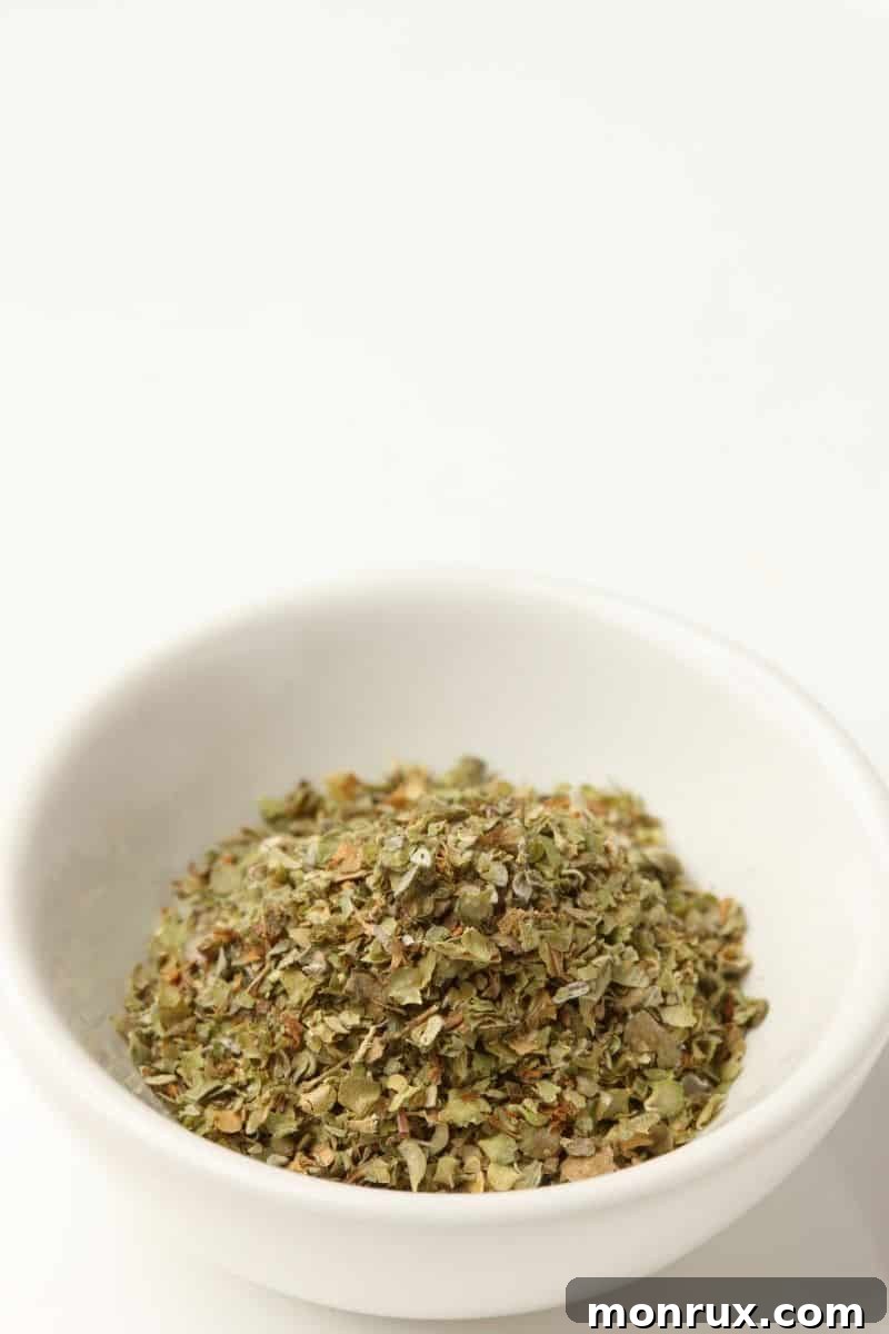 A small bowl of dried marjoram, showing its fine texture.