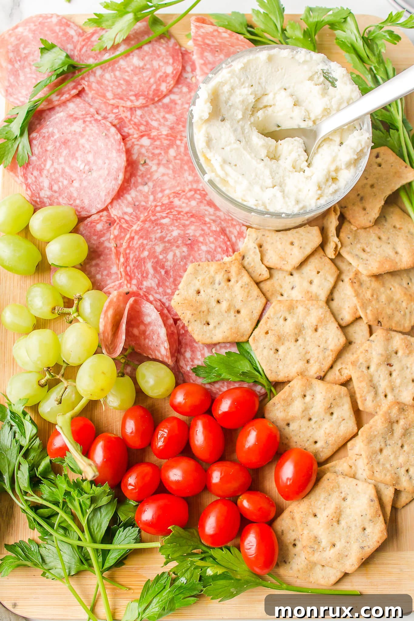 A dairy-free and gluten-free charcuterie board meticulously arranged with a variety of snacks, ready to be served to guests, showcasing a beautiful spread.