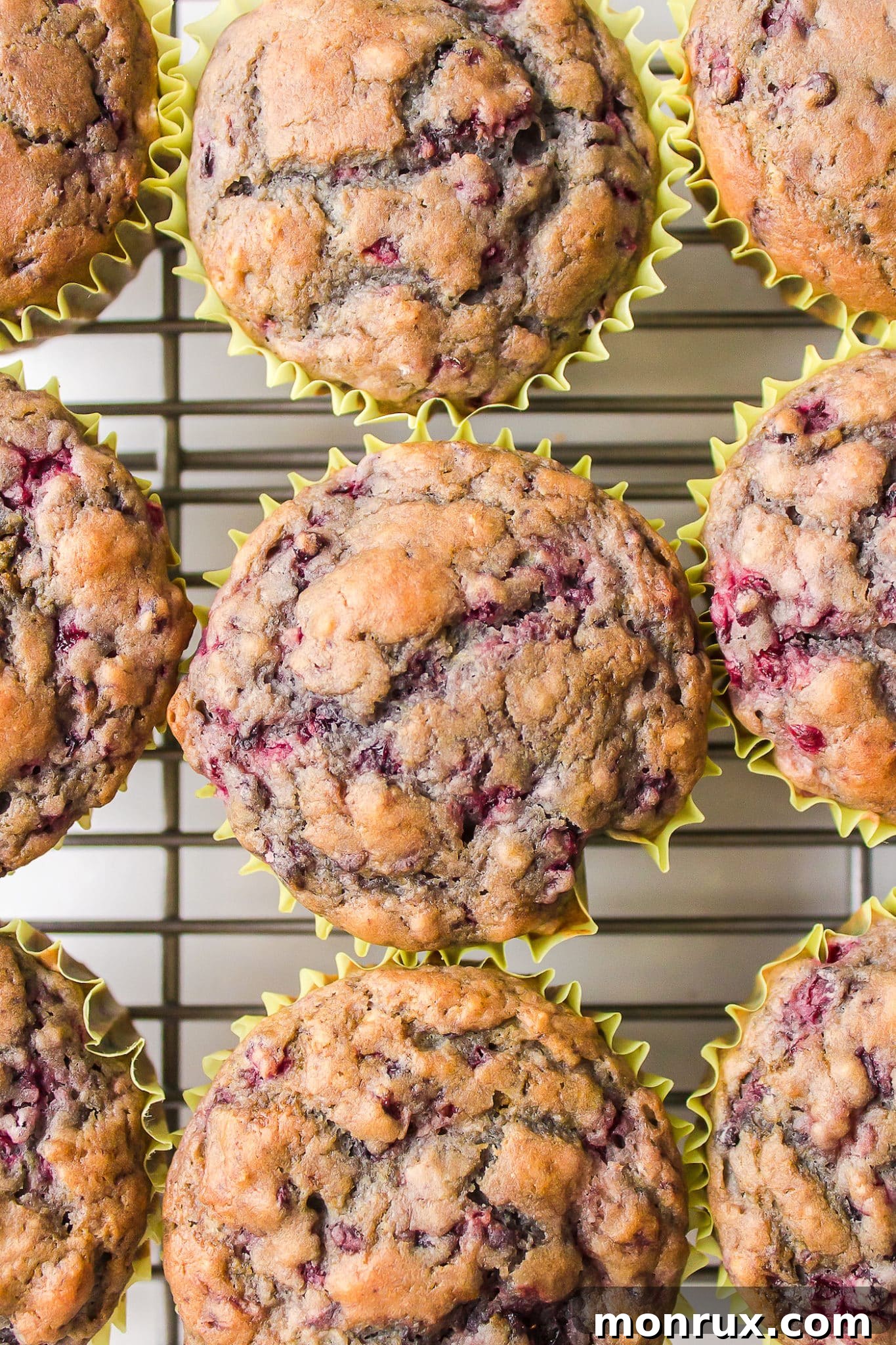Top down shot of gluten-free blackberry muffins on a metal cooling rack.