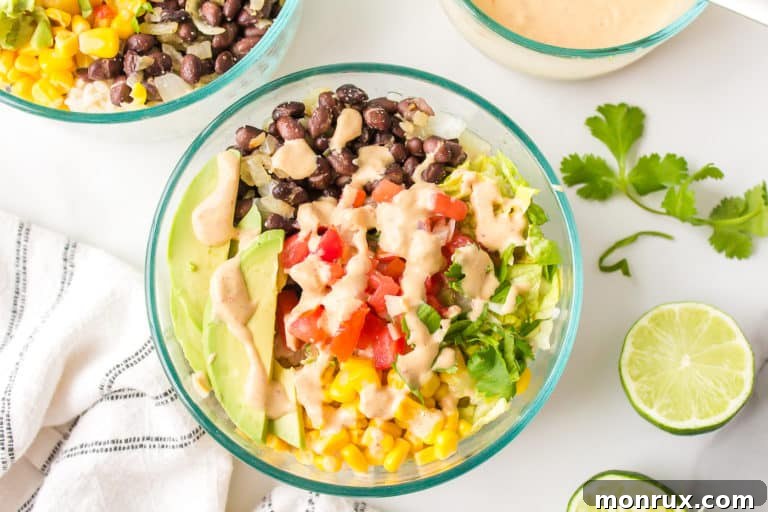 A clear glass bowl with a serving of Mexican brown rice Buddha bowl.