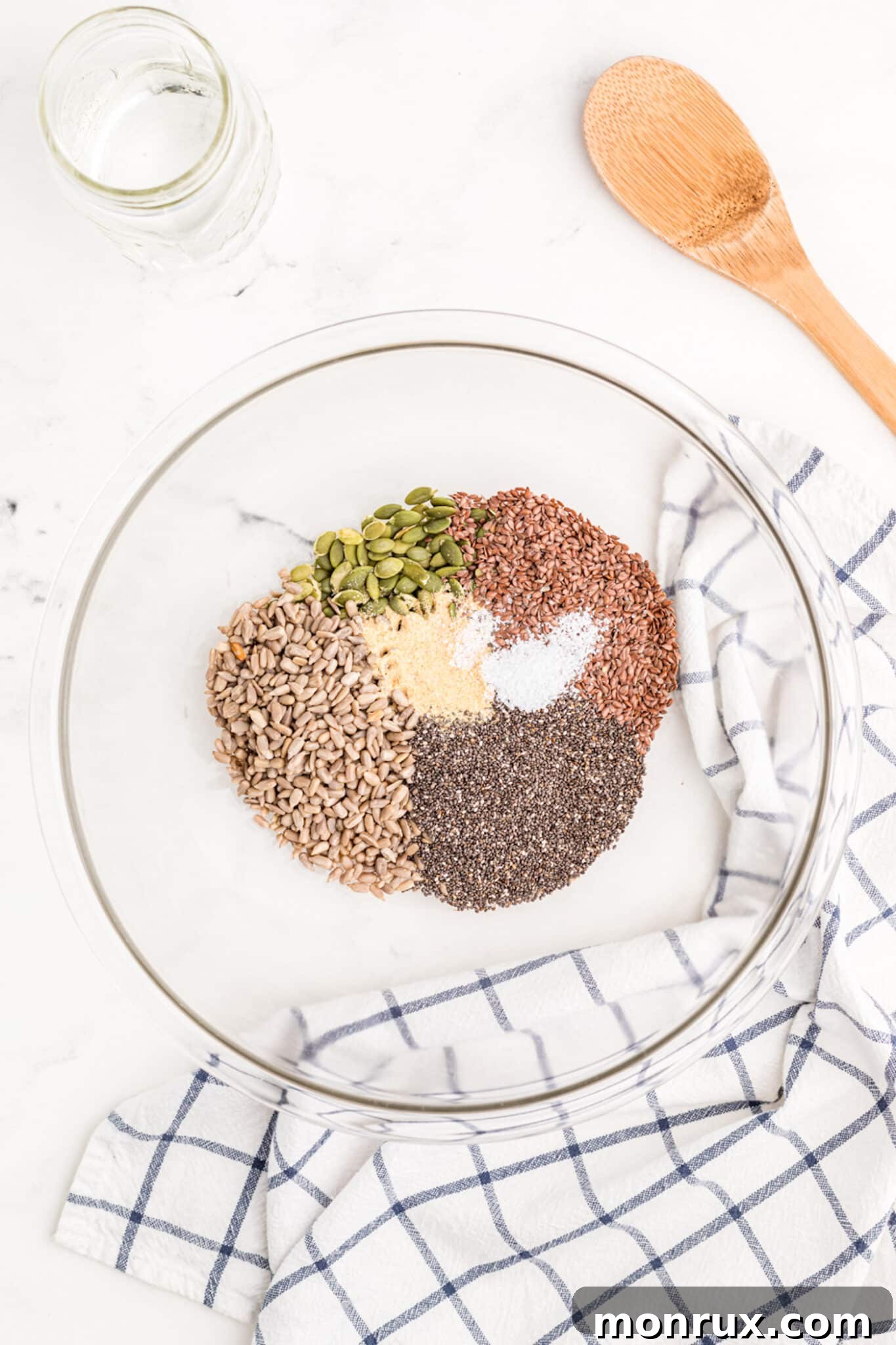 A mixing bowl filled with various dry seed cracker ingredients, perfectly combined and ready for the next step.