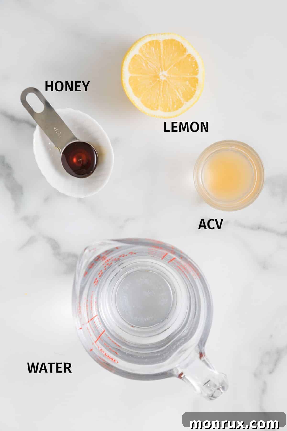 Key ingredients laid out on a white surface for making the healthy ACV and lemon drink.