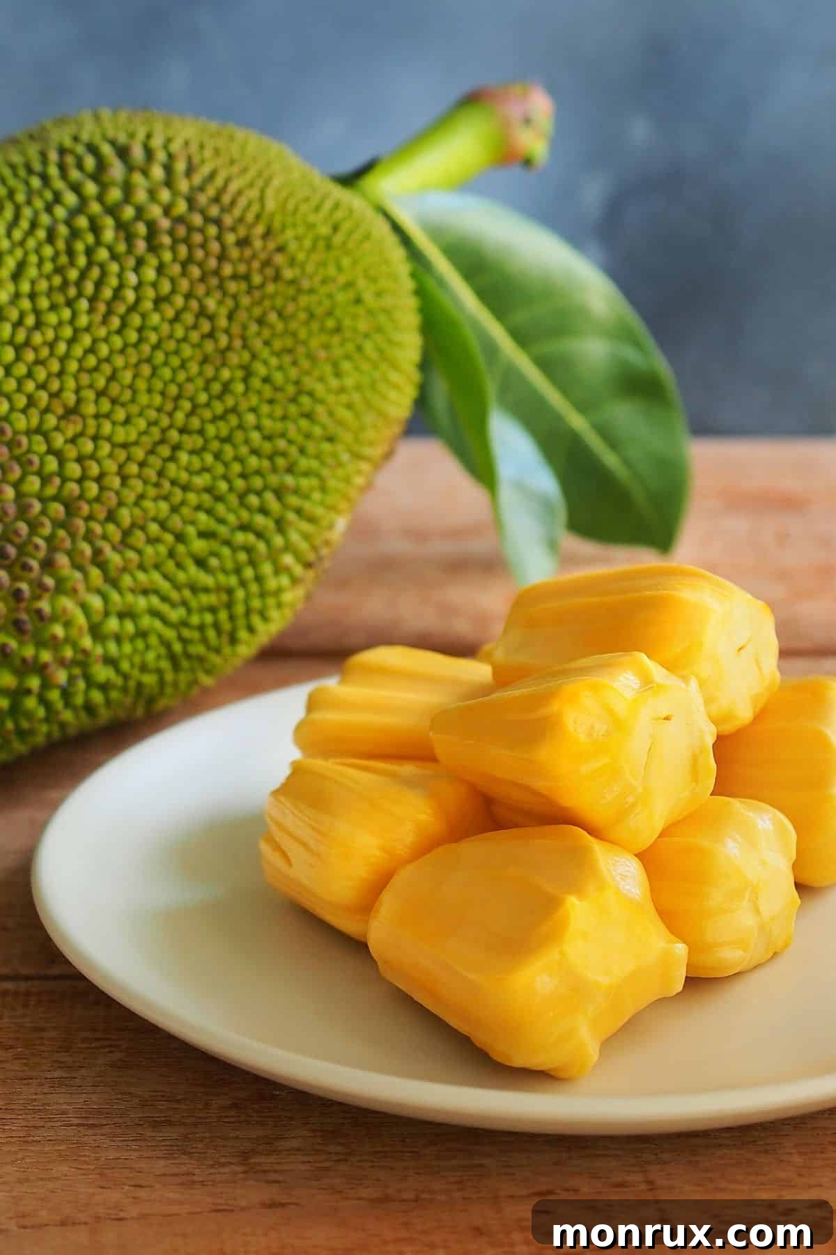 A large jackfruit on a tabletop, highlighting its unique texture.