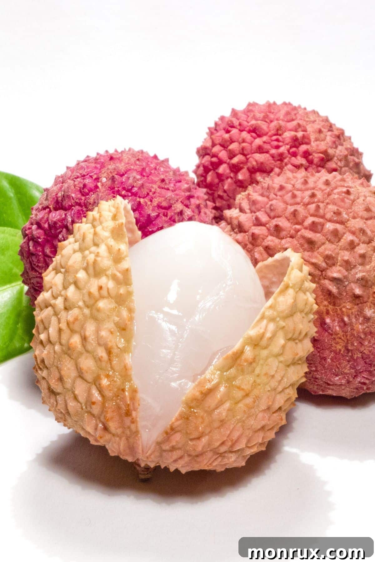 A cluster of fresh lychee fruit on a table.