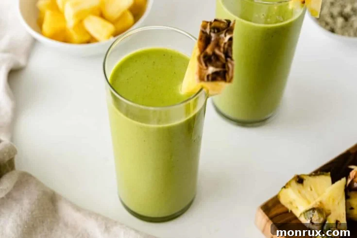 Mango pineapple spinach smoothie made in a food processor.