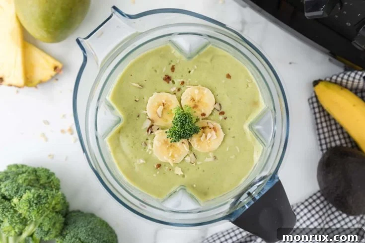 Broccoli smoothie with pineapple in a glass.