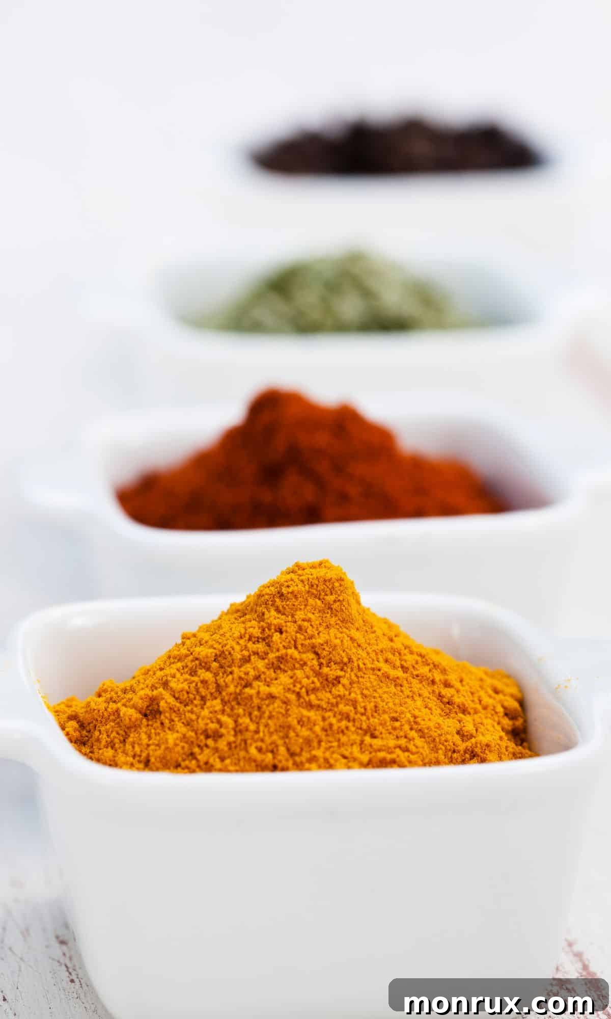 Bowls of old bay seasoning and other spices.