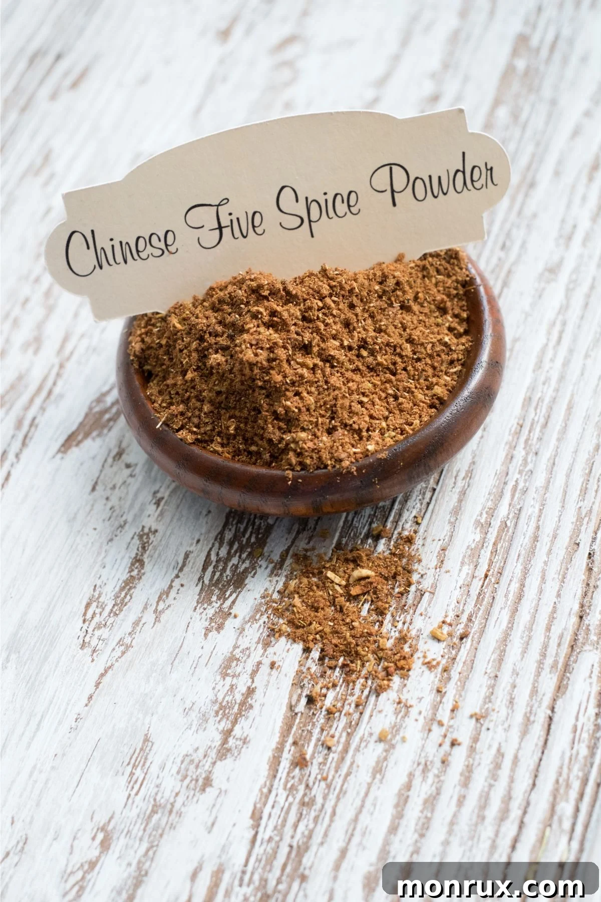 Bowl containing Chinese five spice powder seasoning.