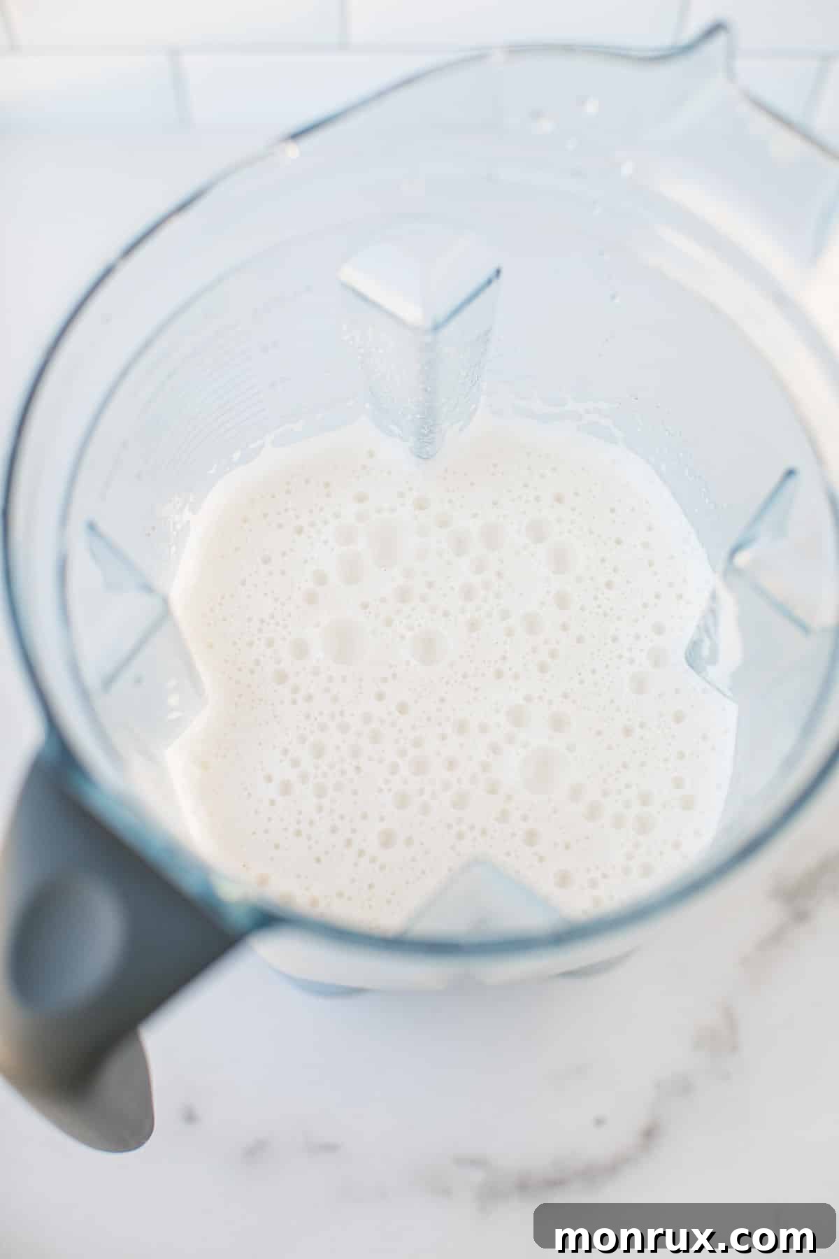 Blended macadamia milk swirling smoothly in a high-speed blender.