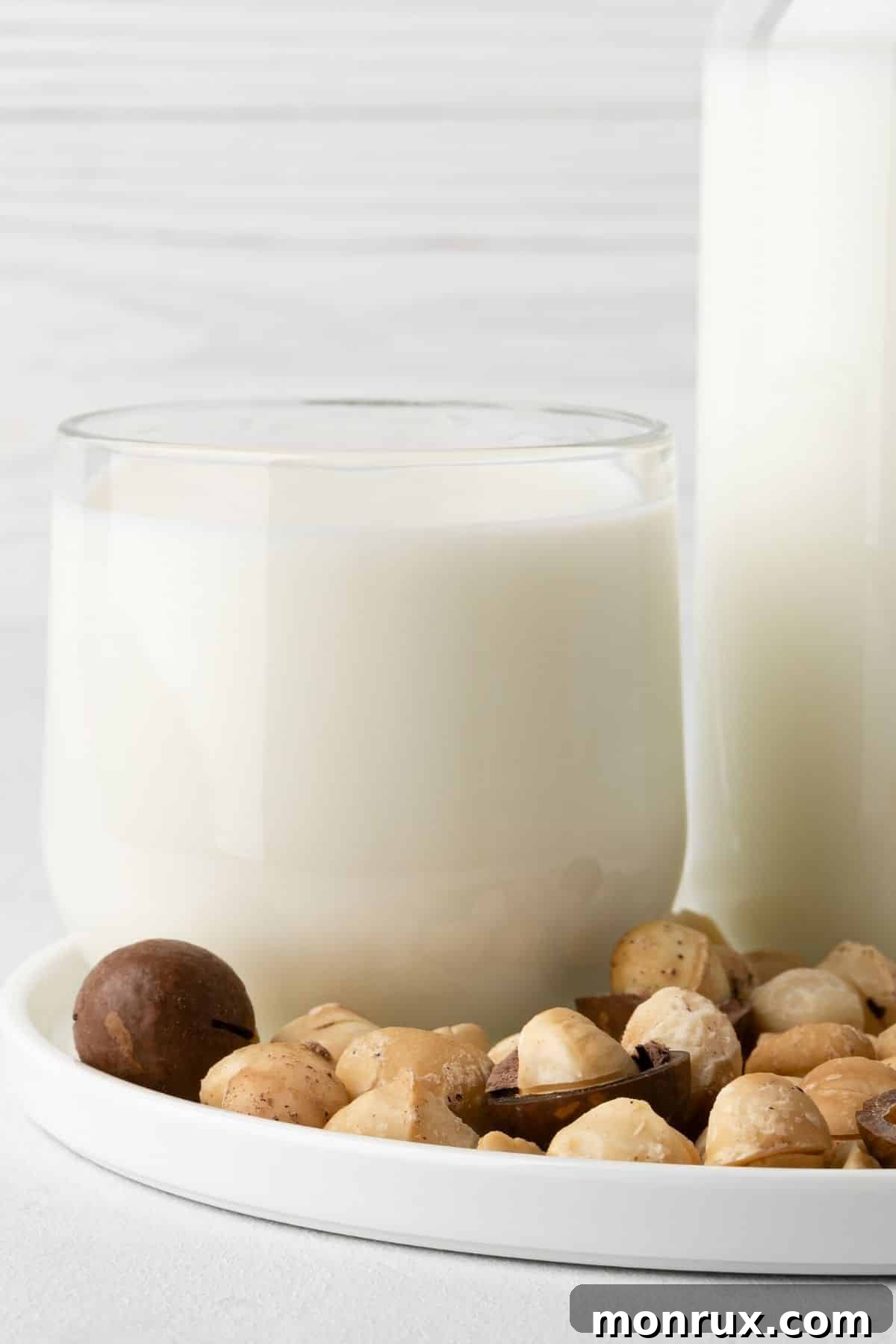A tall glass of creamy macadamia nut milk, inviting to drink.