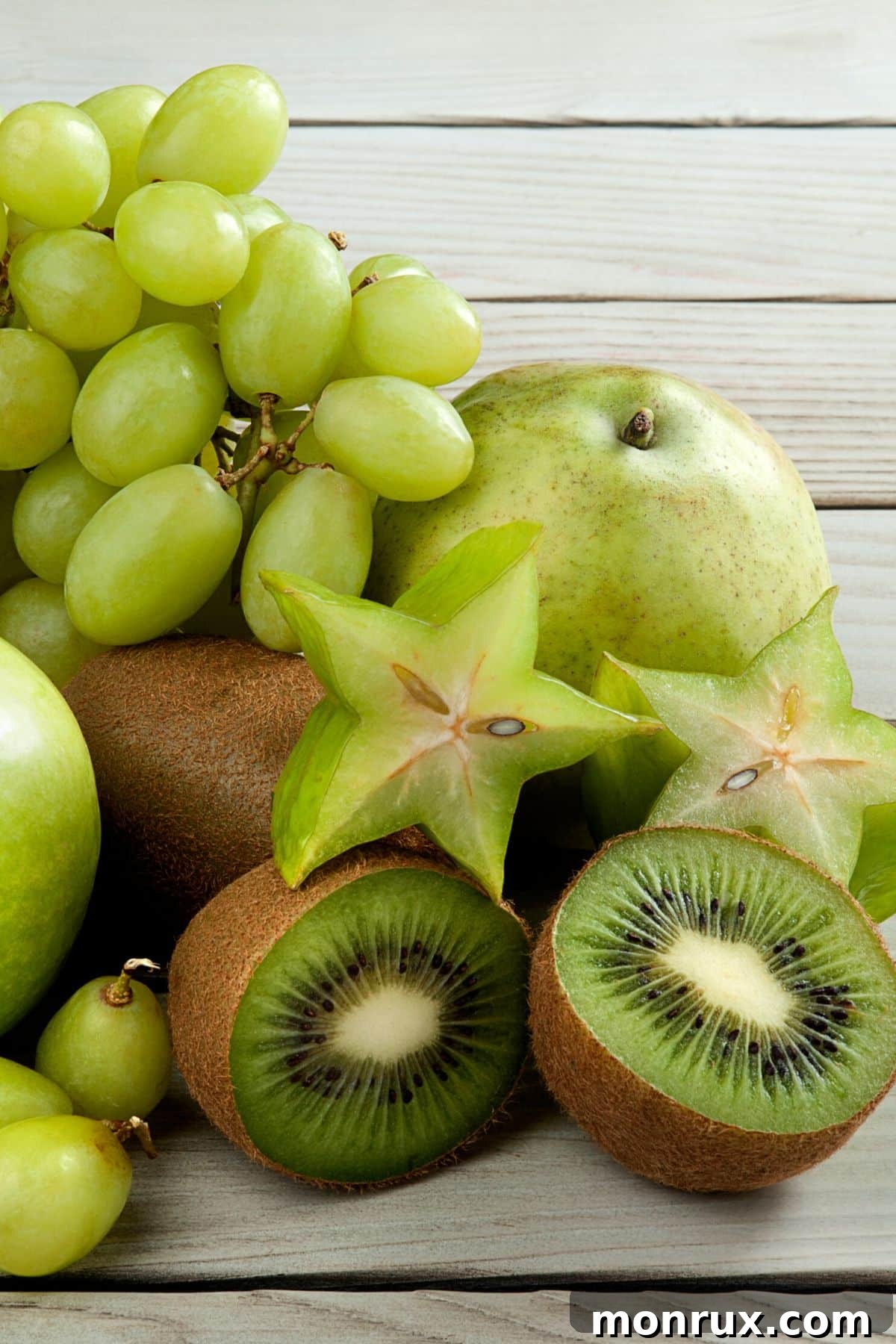 A vibrant selection of the best green fruits, including kiwi, starfruit, and green grapes.