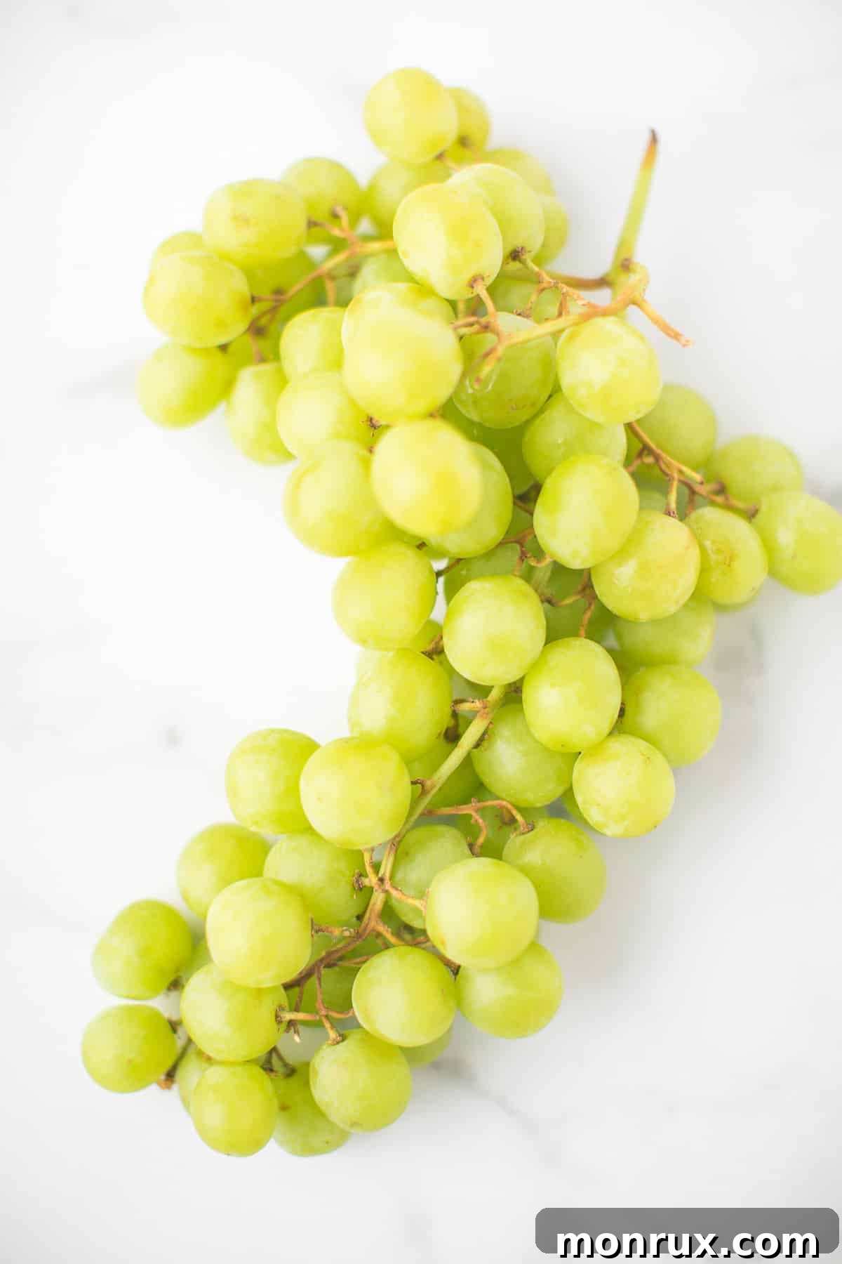A luscious bunch of ripe green grapes.
