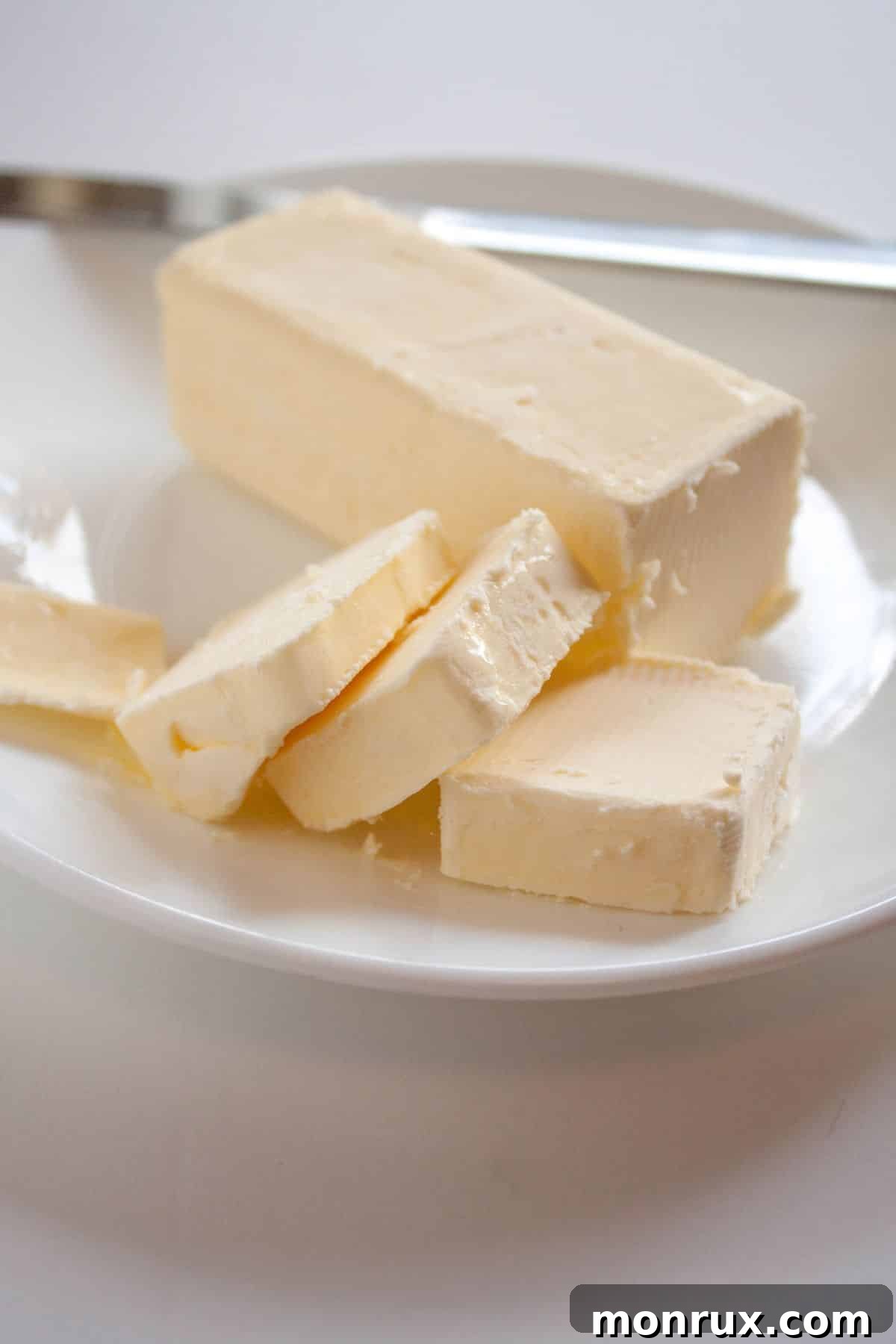 Vegan butter or margarine on a white plate, ready for baking.