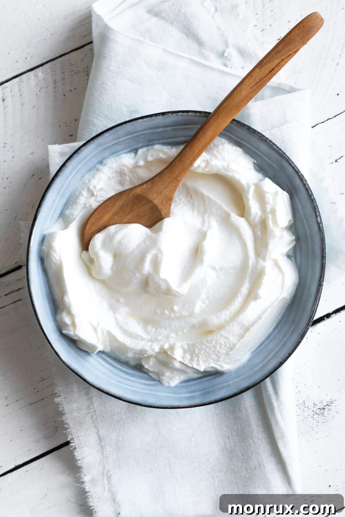 Bowl of Greek yogurt with a wooden spoon.