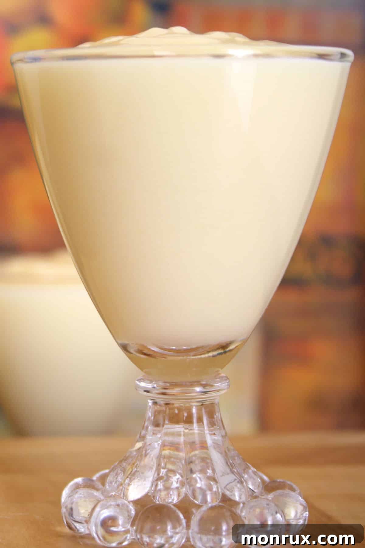 Glass serving cup of vanilla instant pudding.