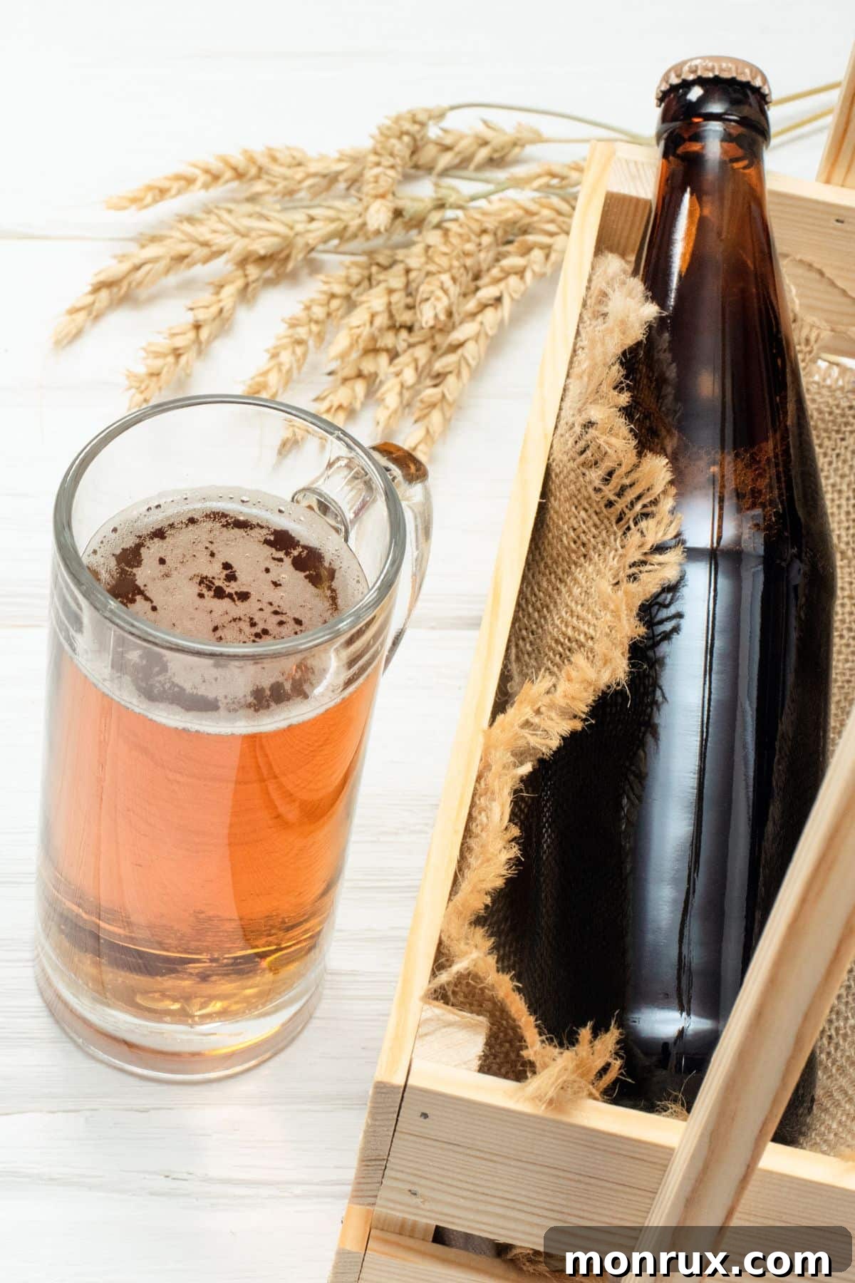 A dark beer bottle next to a full glass of beer, evoking rich, malty flavors.