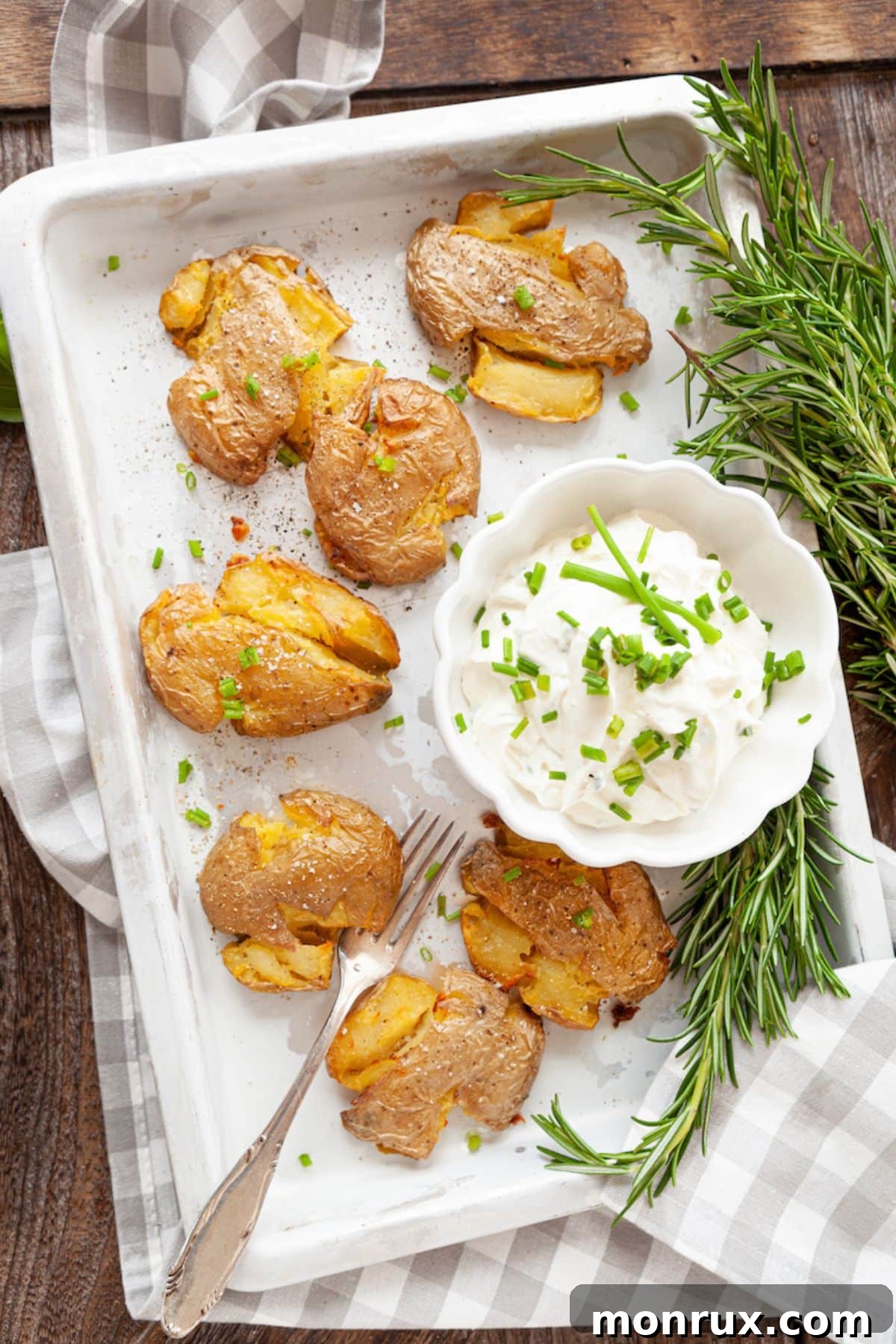 A vibrant platter of golden-brown air fryer smashed potatoes, perfectly crispy and ready to serve.