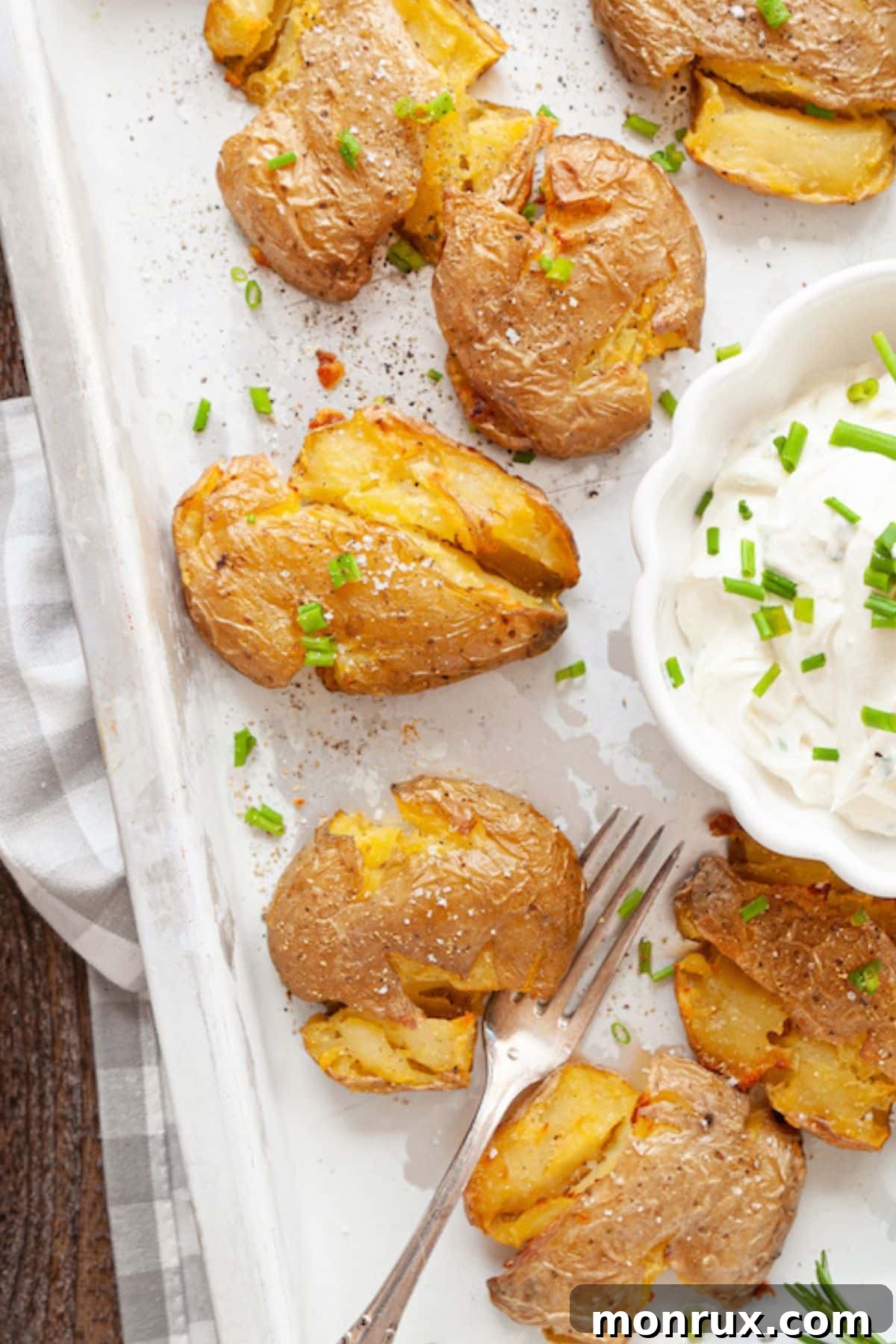 A close-up shot of crispy air fryer smashed potatoes, showing off their golden texture and enticing seasoning.