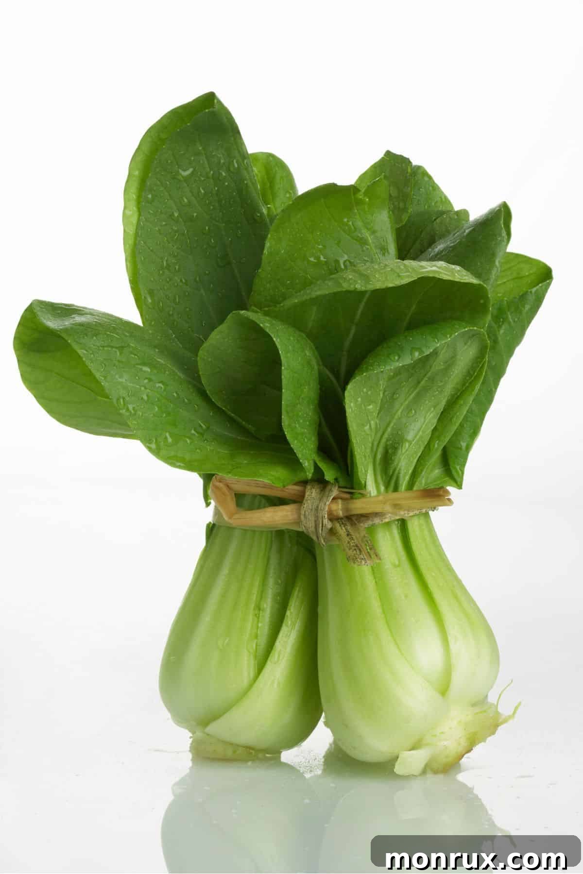 Fresh, crisp bok choy on a wooden table, highlighting its readiness for healthy cooking or juicing.