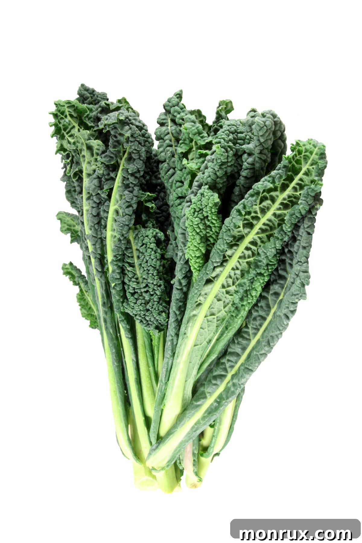 A vibrant bunch of fresh kale leaves on a wooden table, showcasing its robust texture and deep green color.