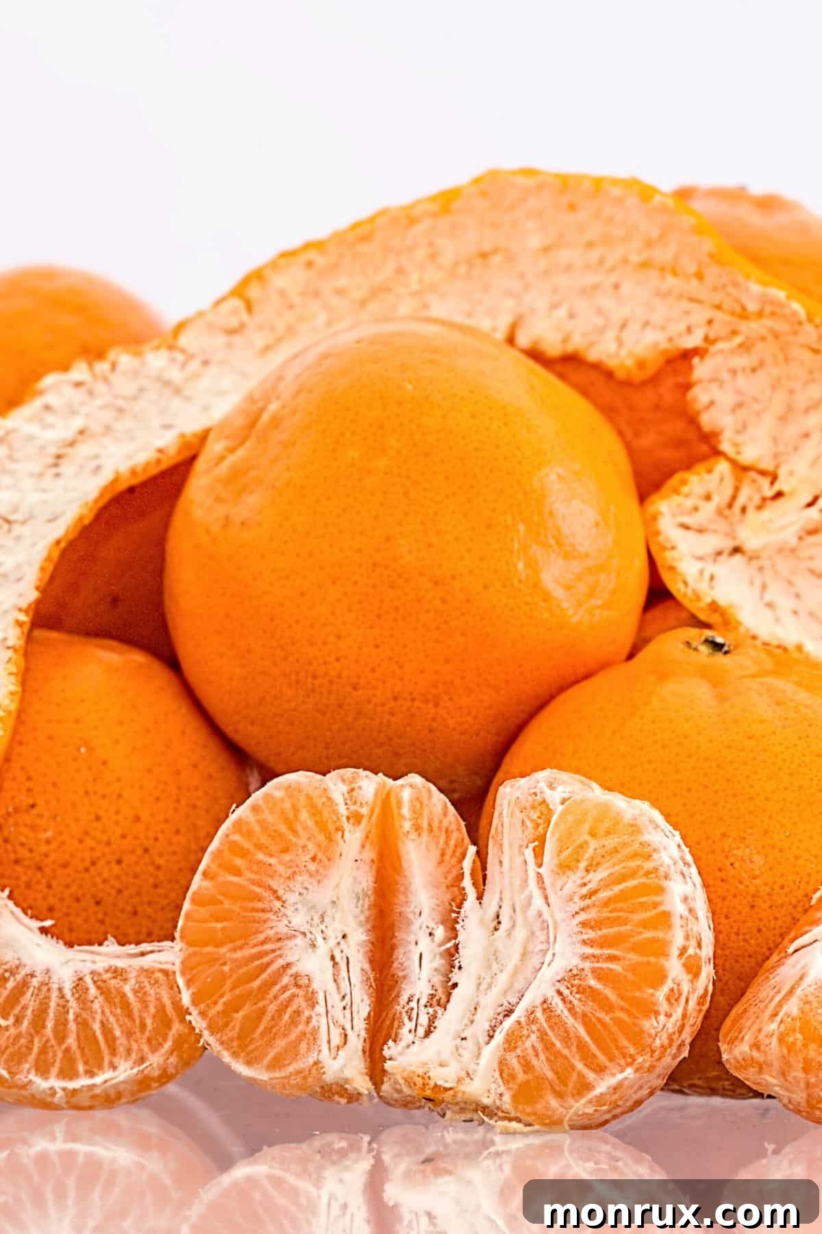Freshly cut Naartjie slices arranged on a rustic wooden table, showing their vibrant citrus flesh.