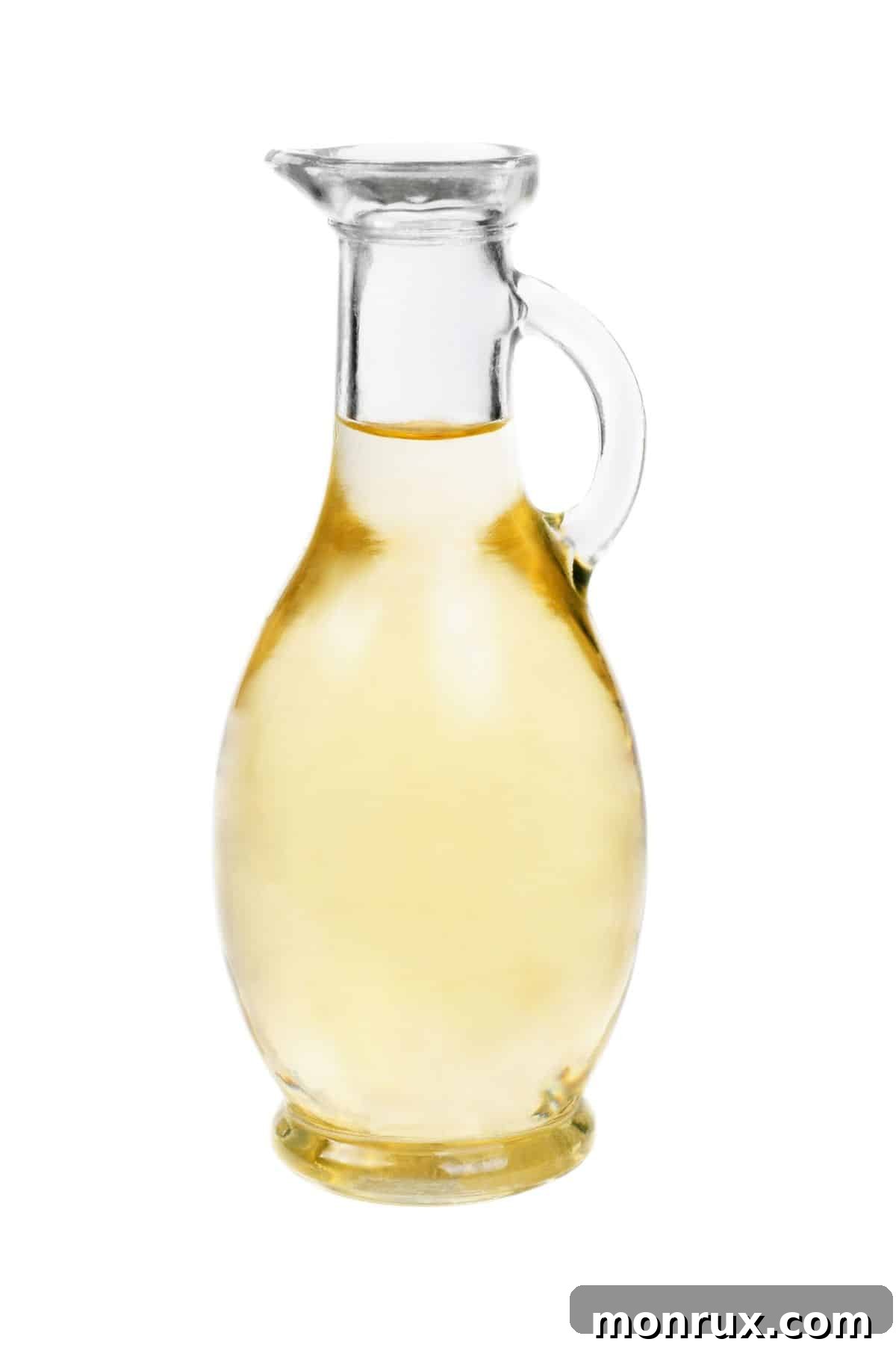 Jar of white wine vinegar on white background.