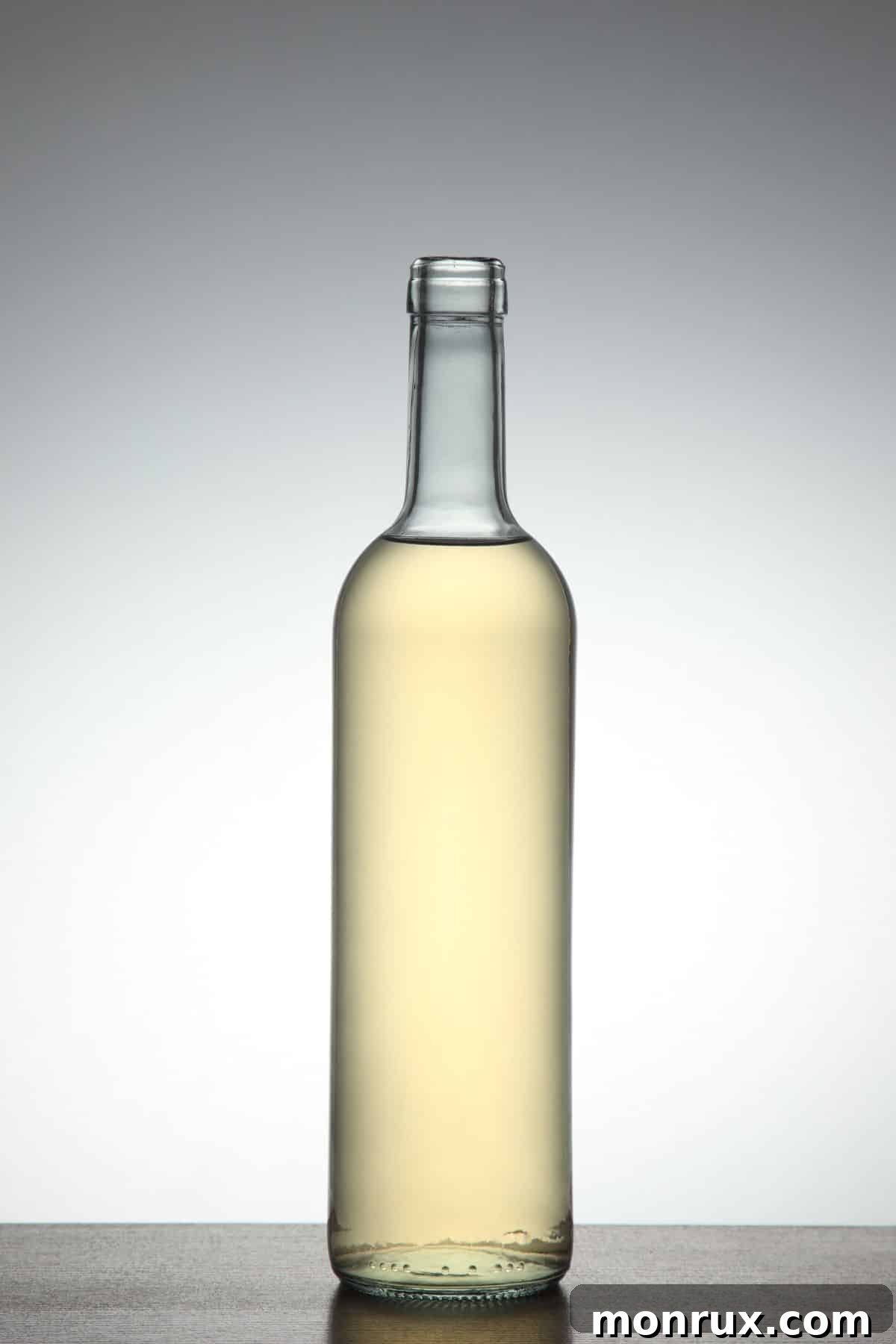 Bottle of champagne vinegar on white background.