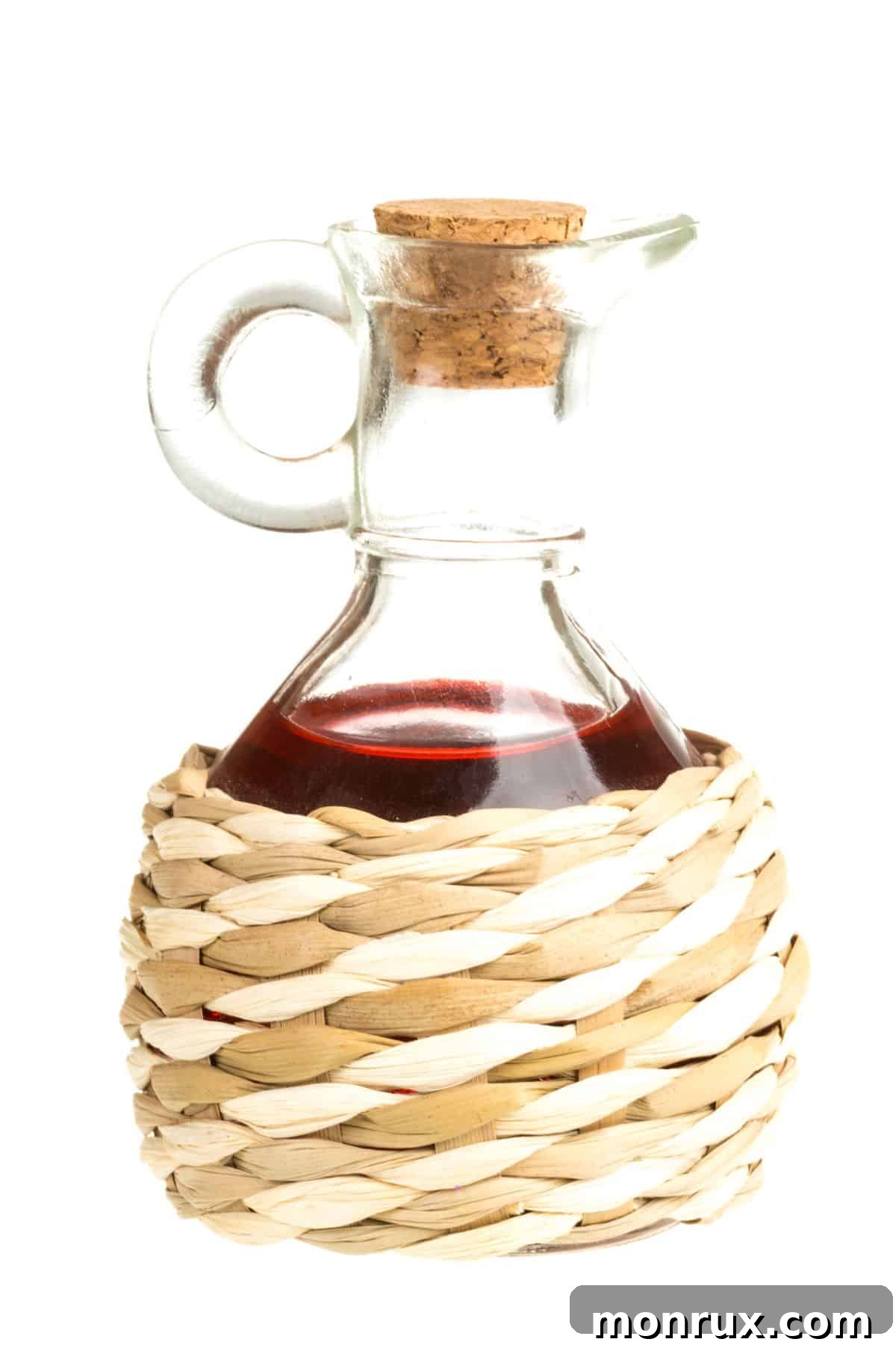 Bottle of red wine vinegar in woven case.