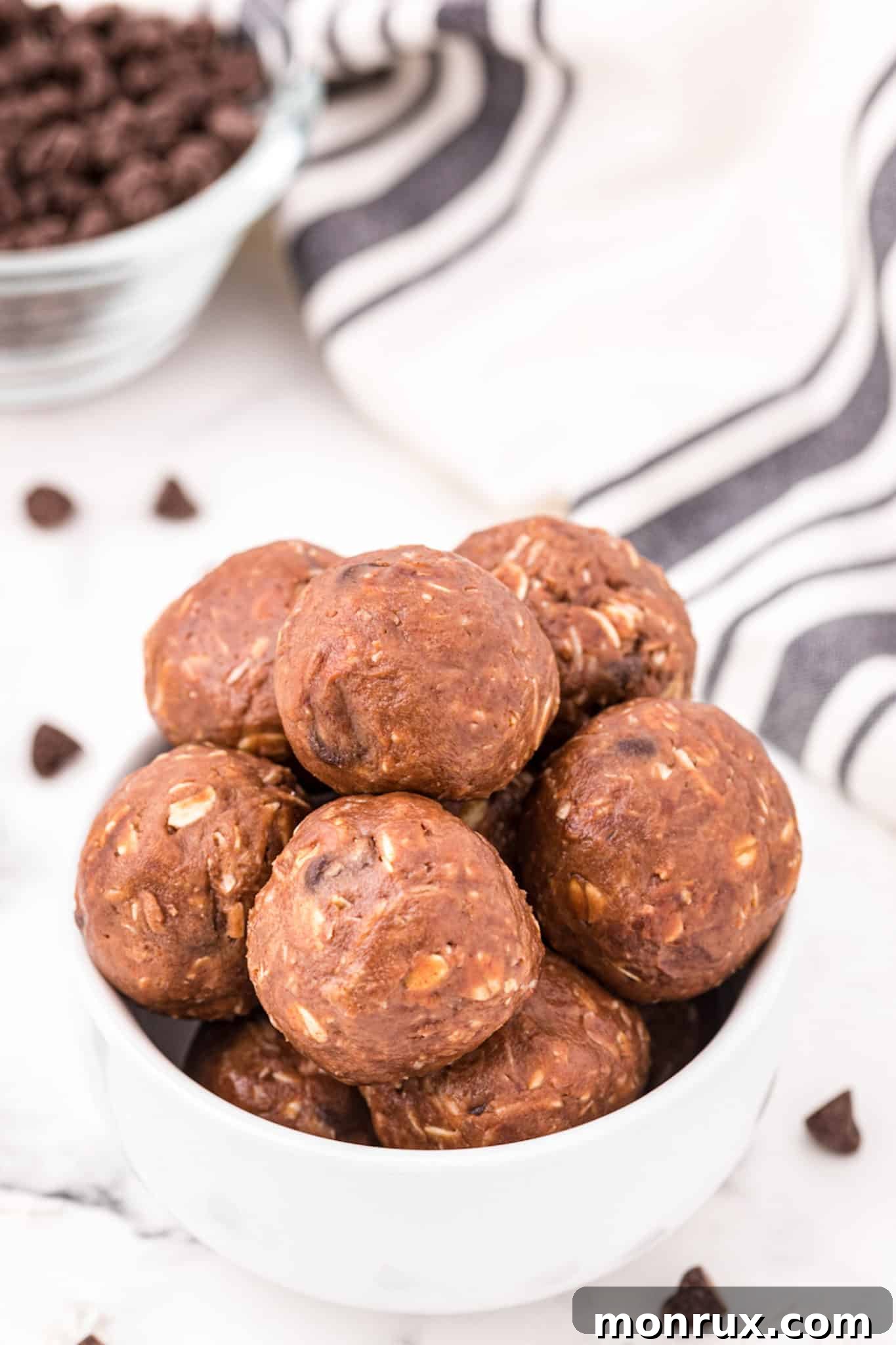 A small rustic bowl filled with perfectly formed chocolate almond butter energy balls, ready to be enjoyed.