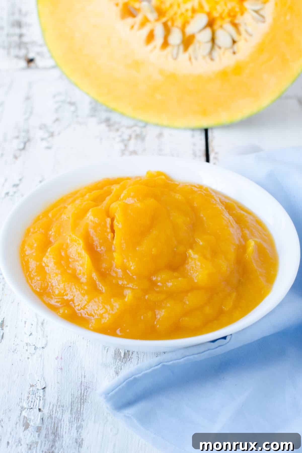 Pureed pumpkin with fresh halved pumpkin.