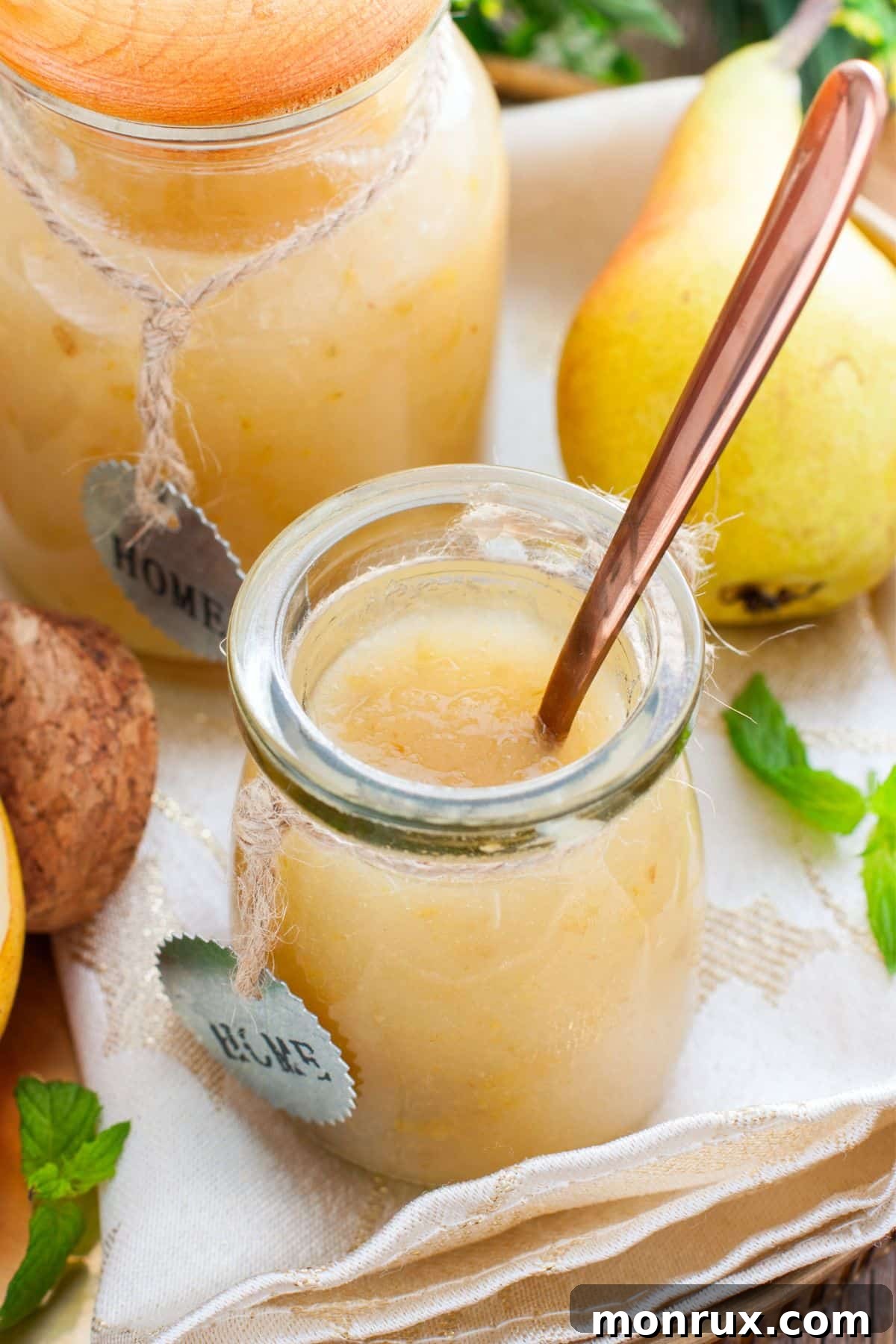 Jar of pureed pears with whole pears.